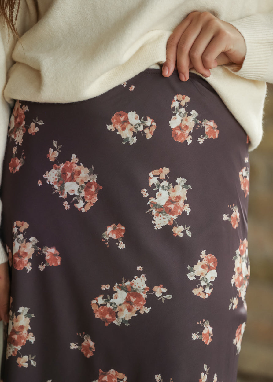 Close-up of charcoal fabric with cream, rust, and muted floral print