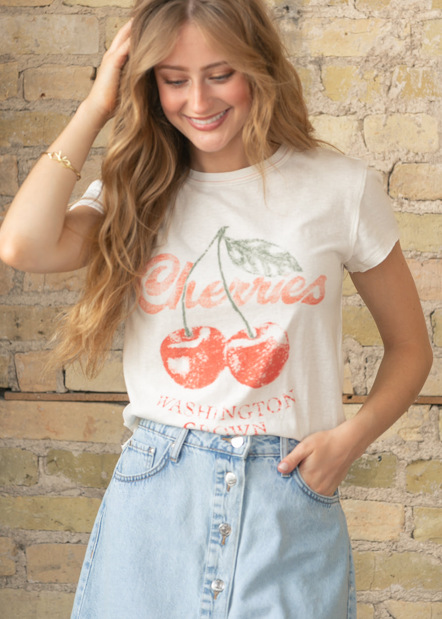 Close up of cherry graphic print on cream Free People tee