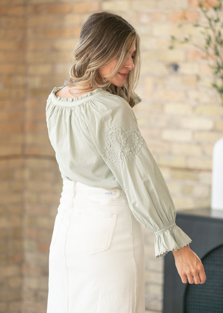 Feminine woven blouse with ruffle sleeve accents
