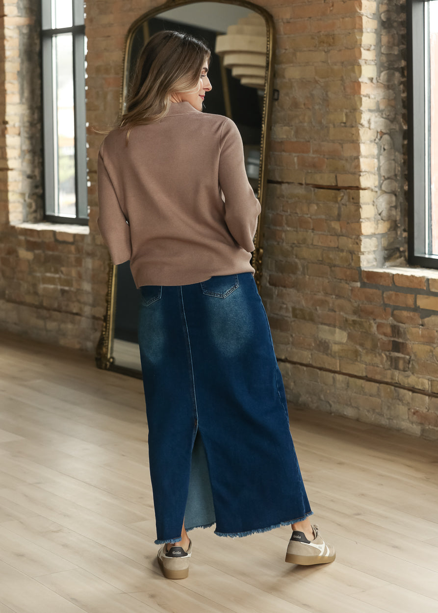 Dusty brown bell sleeve sweater styled with a dark wash denim maxi skirt and sneakers.