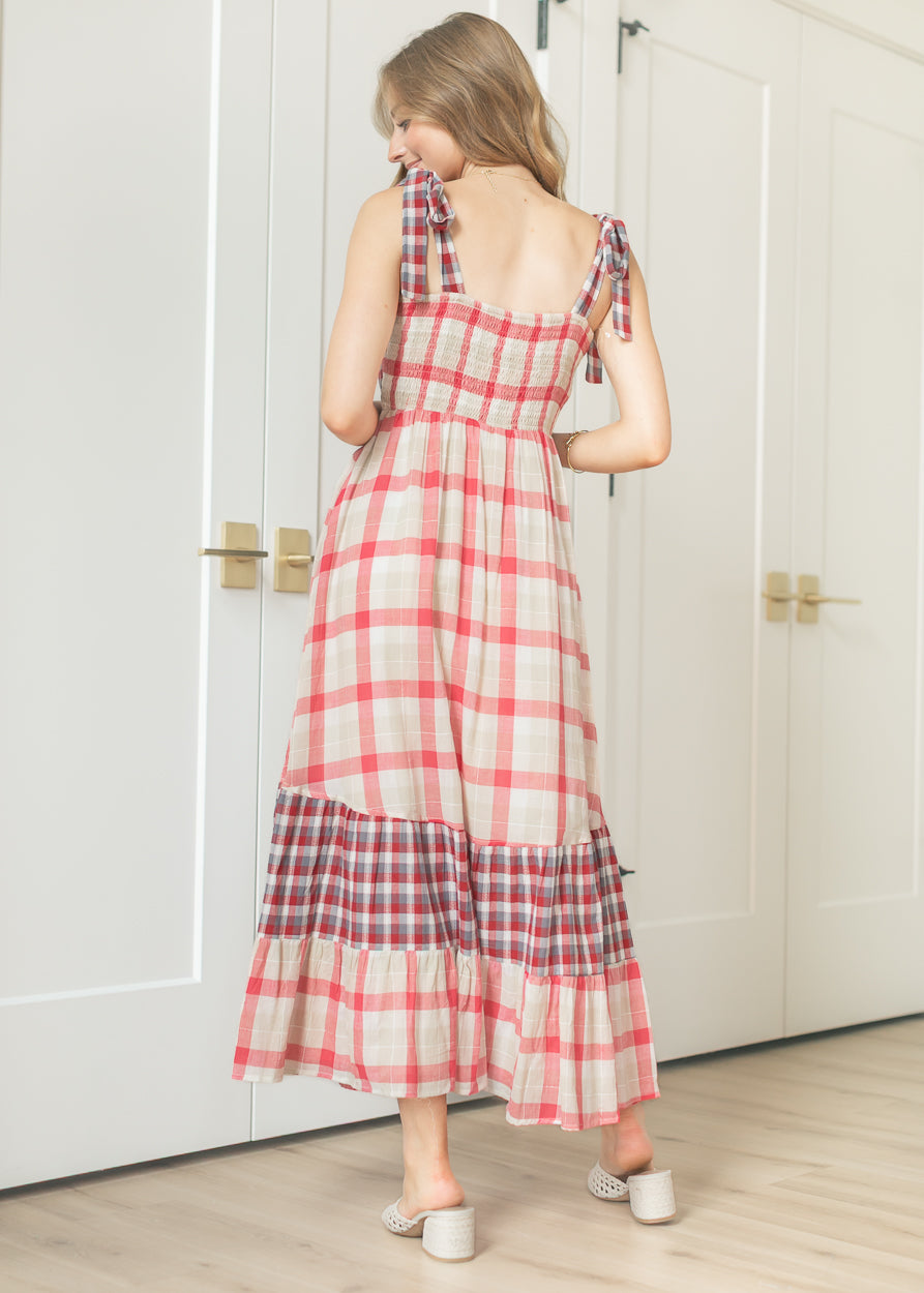 Back view of plaid maxi dress showing smocked back bodice and tiered contrast hem