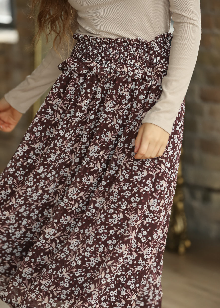 Side view of brown floral midi skirt showing its soft drape and mid-calf length.