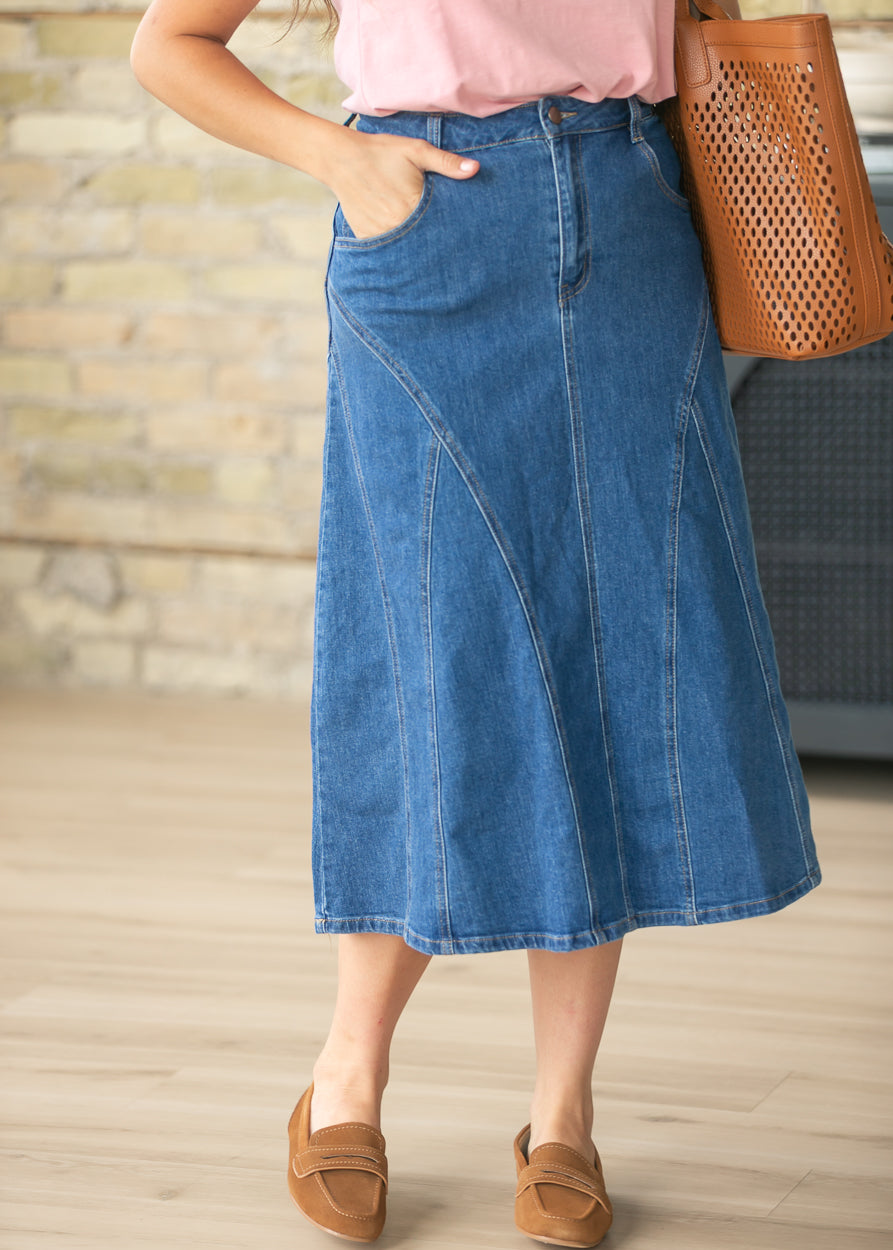 Medium wash denim midi skirt with flattering A-line silhouette and stitched panel design.