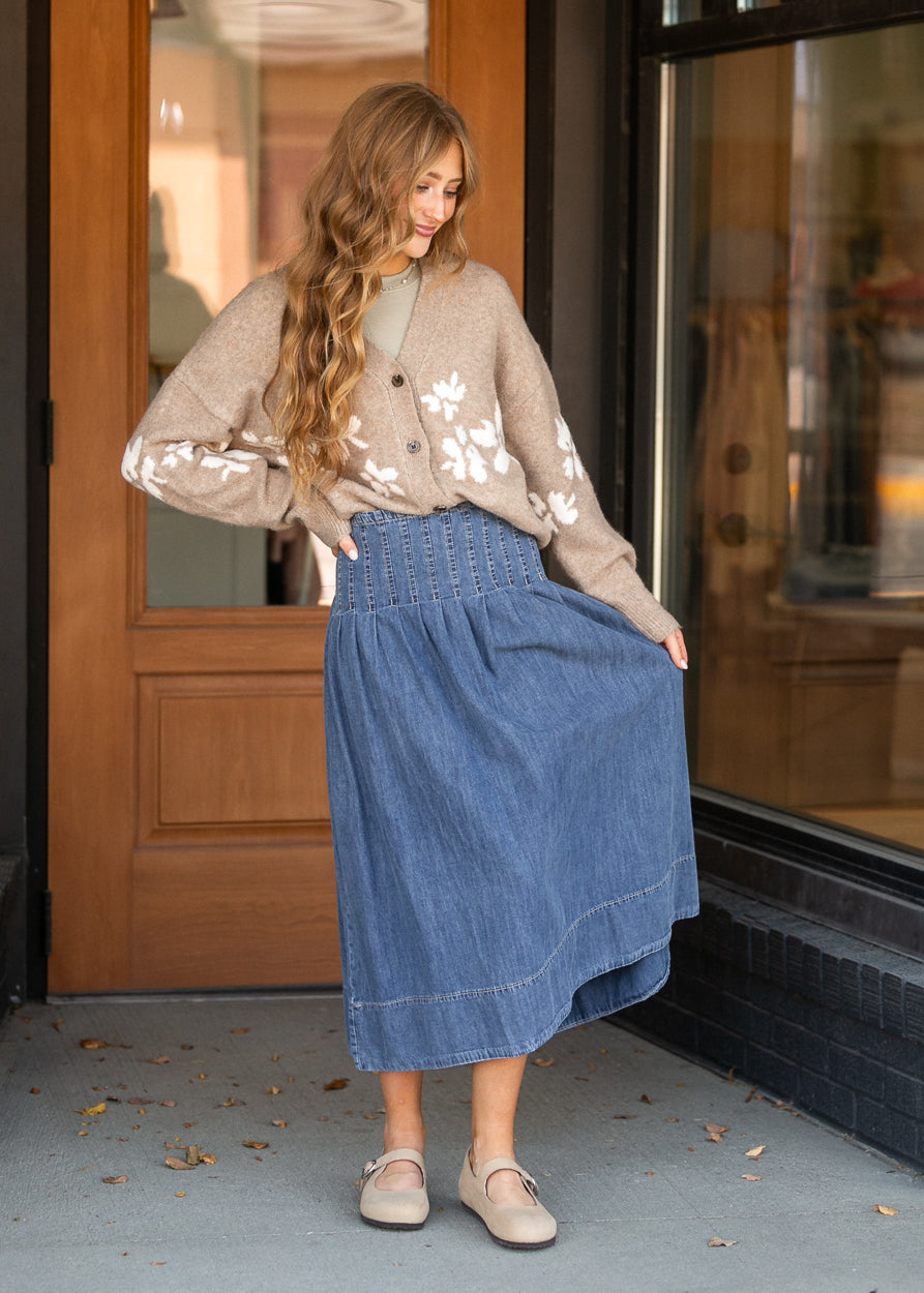 Oatmeal floral cardigan styled with a blue denim midi skirt and neutral flats.