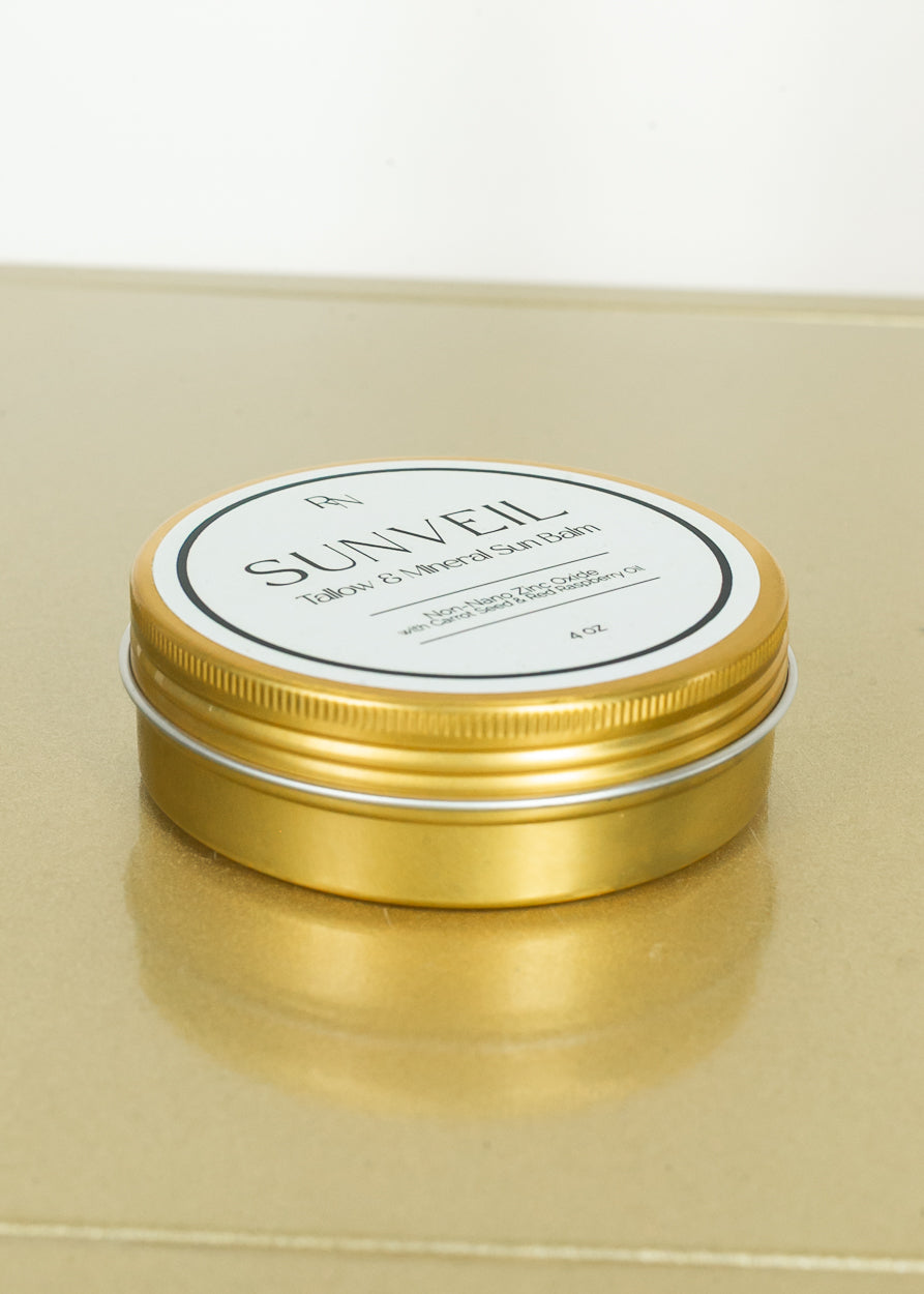 SunVeil tallow and mineral sun balm displayed in gold tin packaging.
