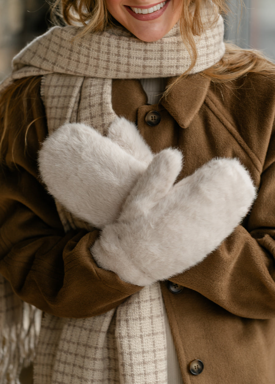 Soft ivory-grey faux fur mittens with plush texture, photographed on a white background.
