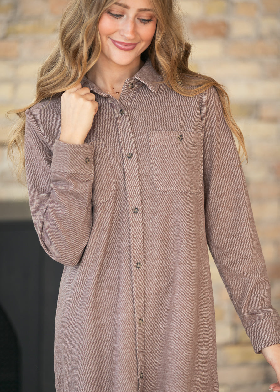 Close-up of Clove Heather Leslie dress with pointed collar, button front, cuff buttons, and chest pockets.