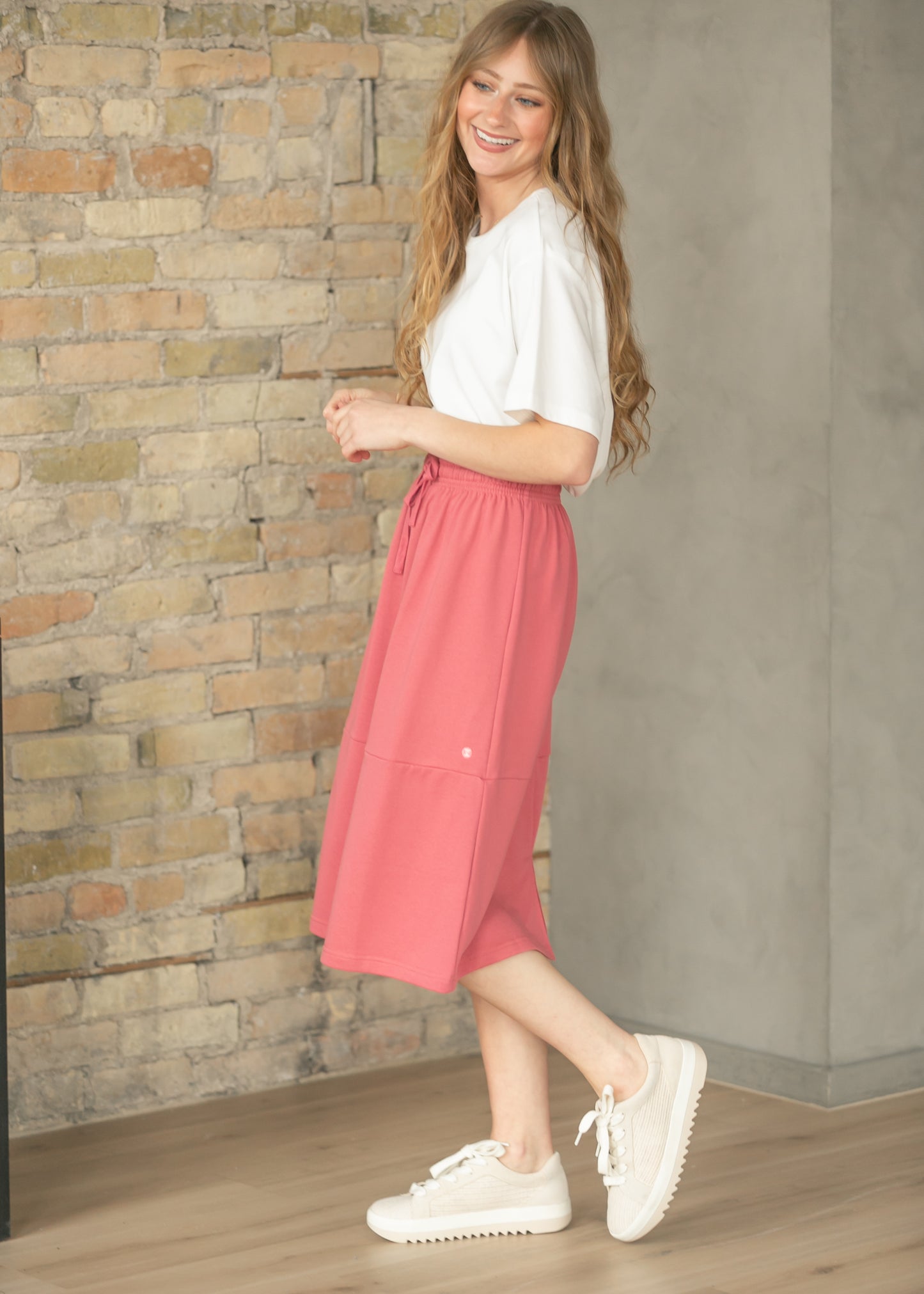 Side view of mulberry sweatshirt midi skirt showing its flowing A-line silhouette.