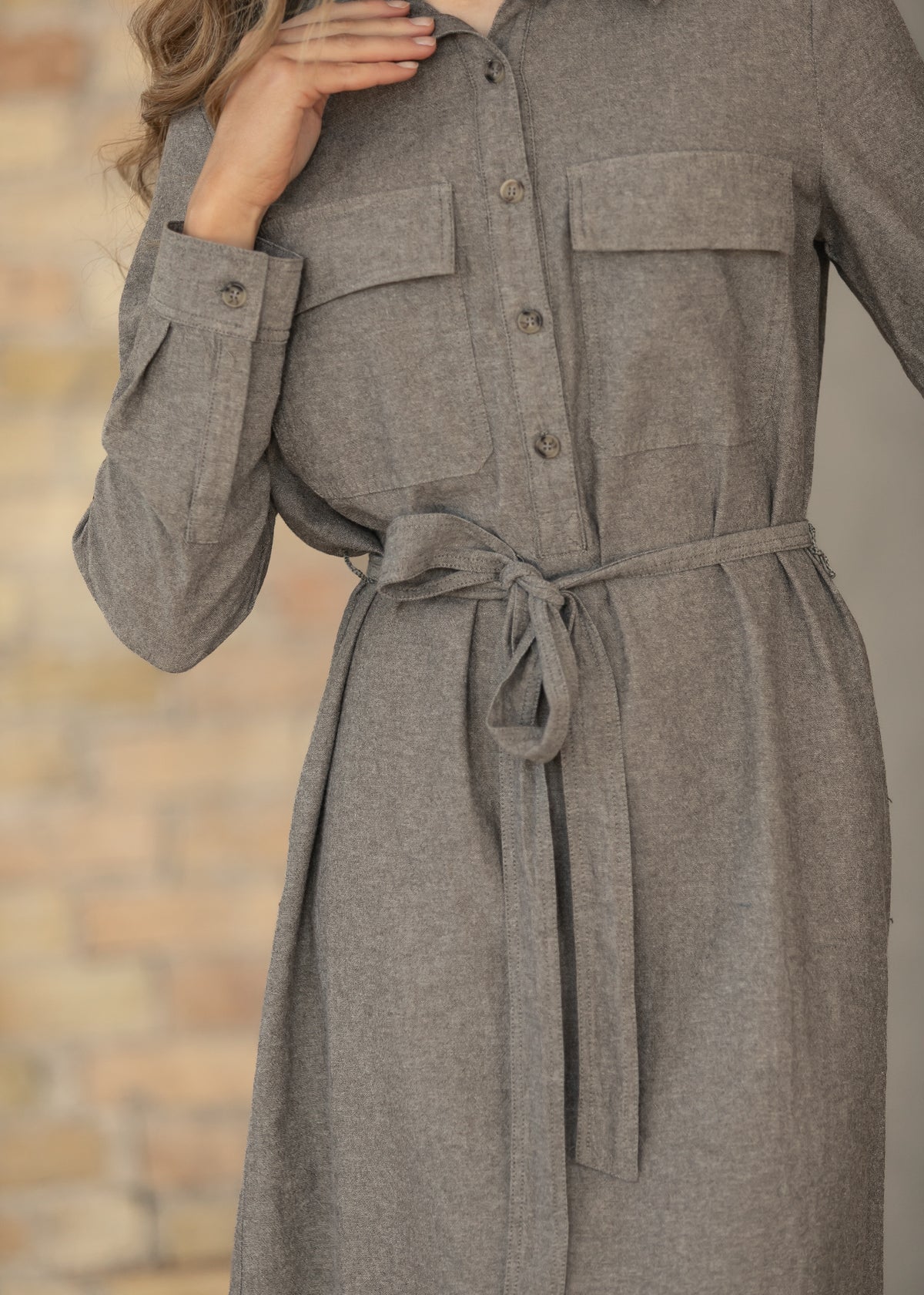 Close-up of the tie belt of brown chambray dress.