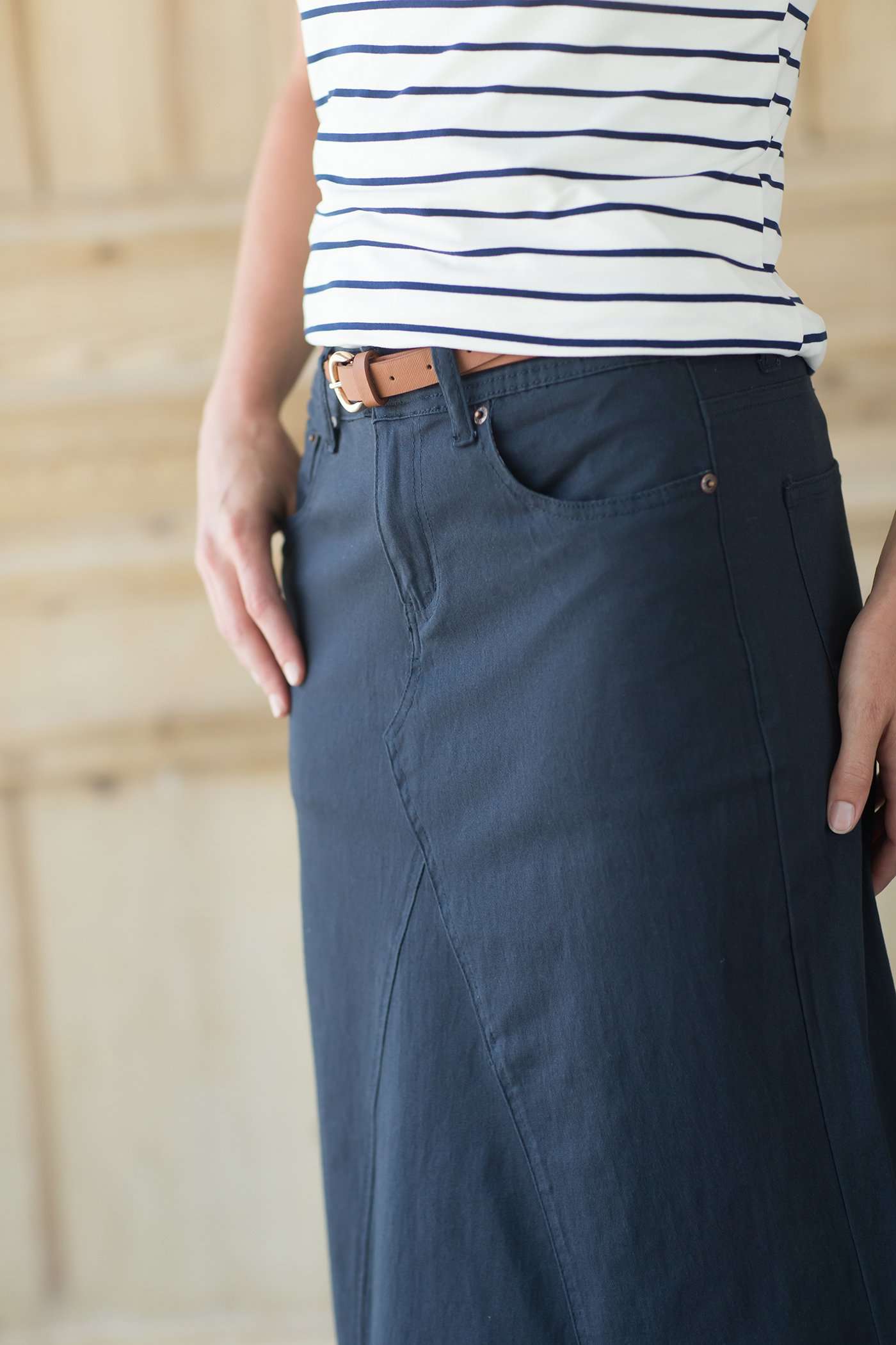 Shop this long, modest navy skirt with a beautiful a-line insert.
