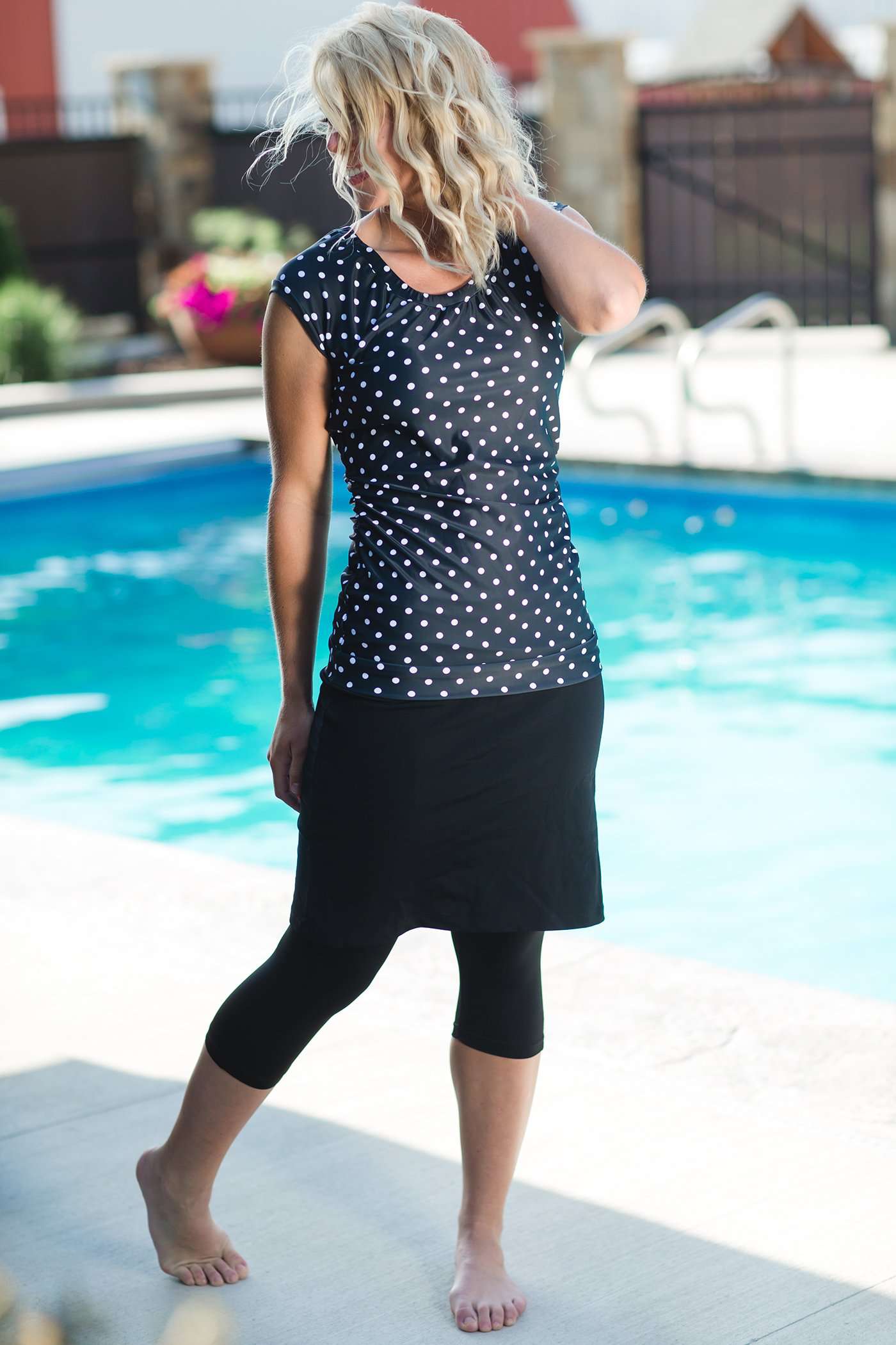 Women's modest cap sleeve swim suit top, black with white polka dots.