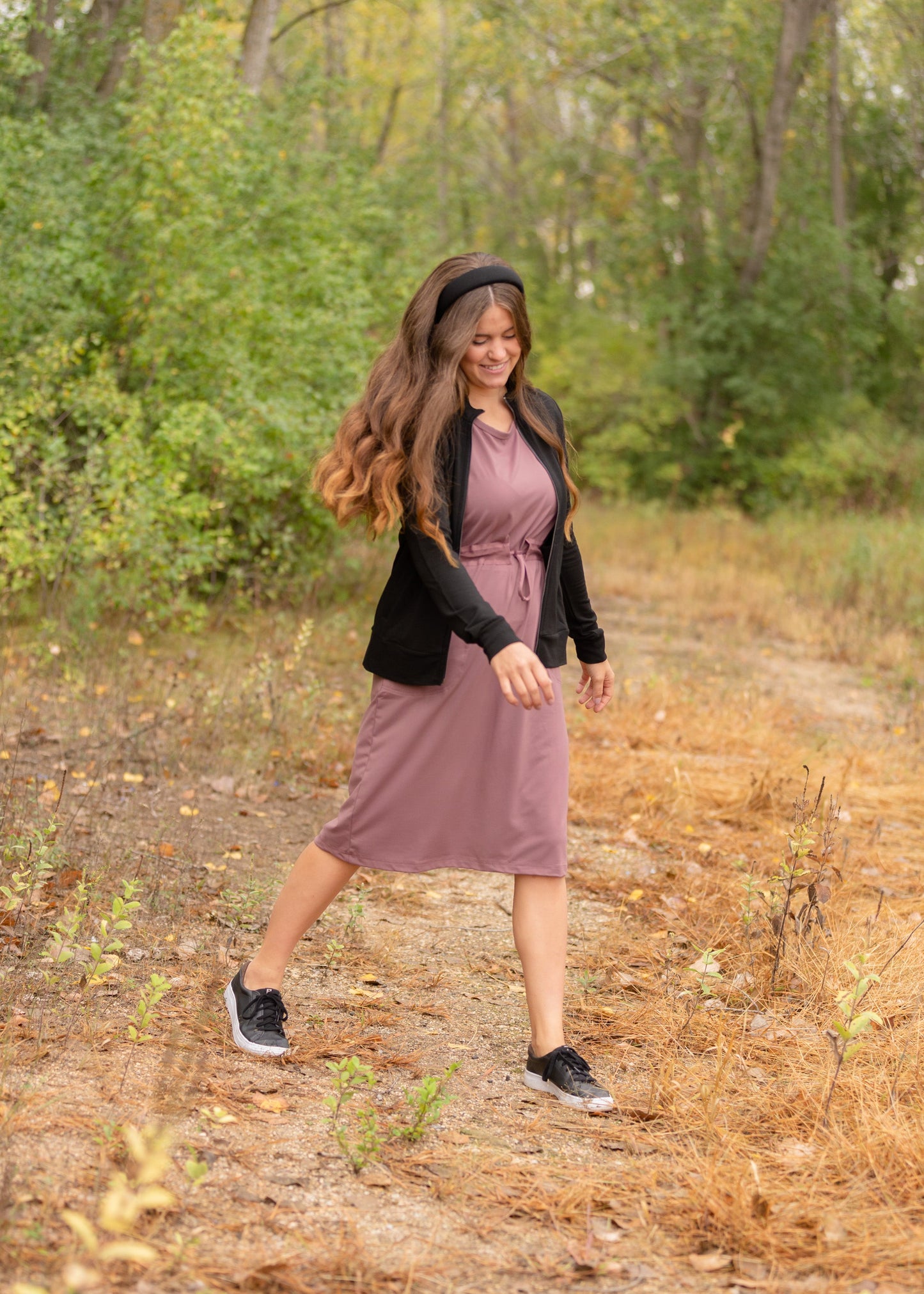 This is a Cinch Waist Athletic midi dress in a purpley taupe color that has a mesh detail and large side pockets.