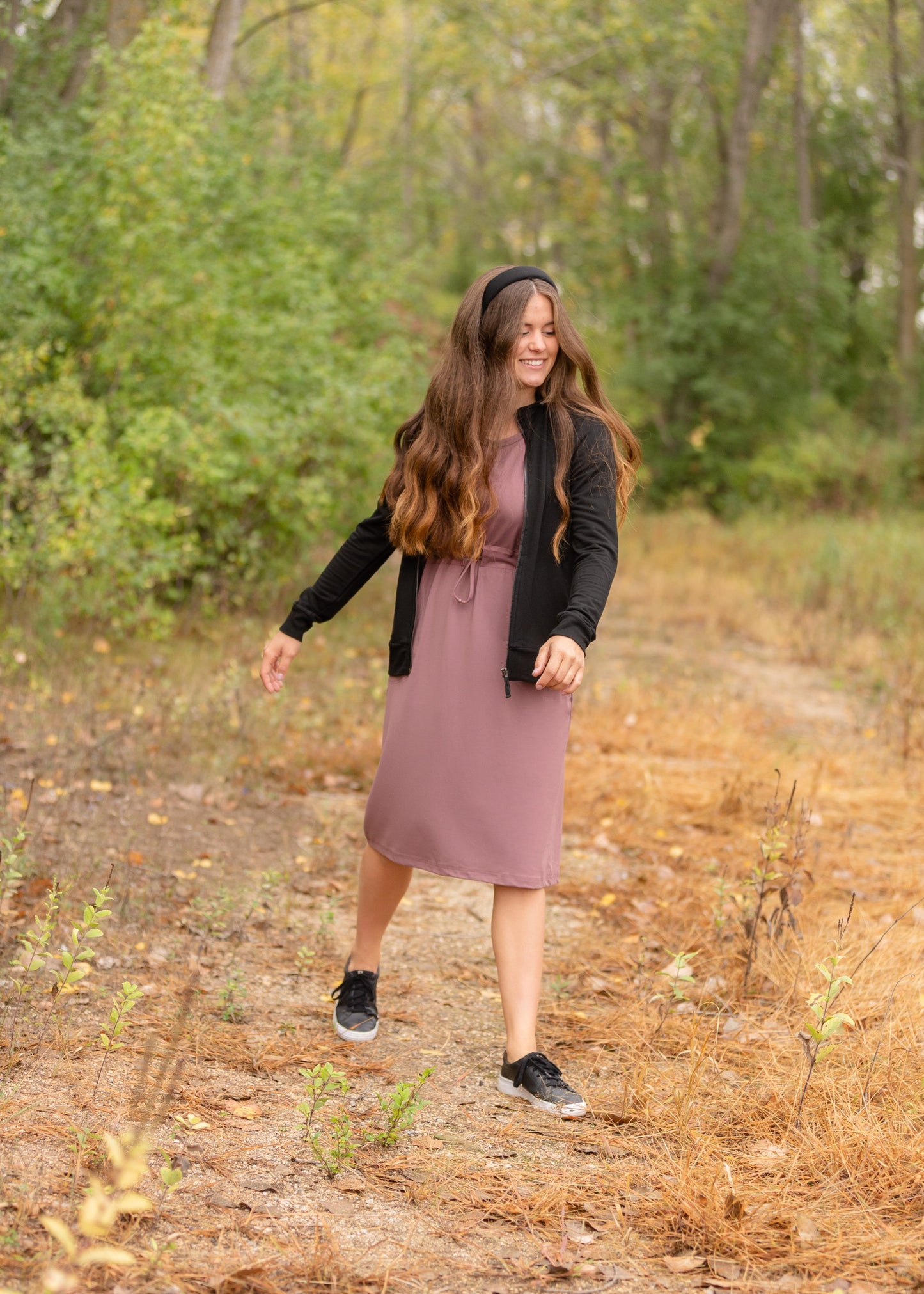 This is a Cinch Waist Athletic midi dress in a purpley taupe color that has a mesh detail and large side pockets.