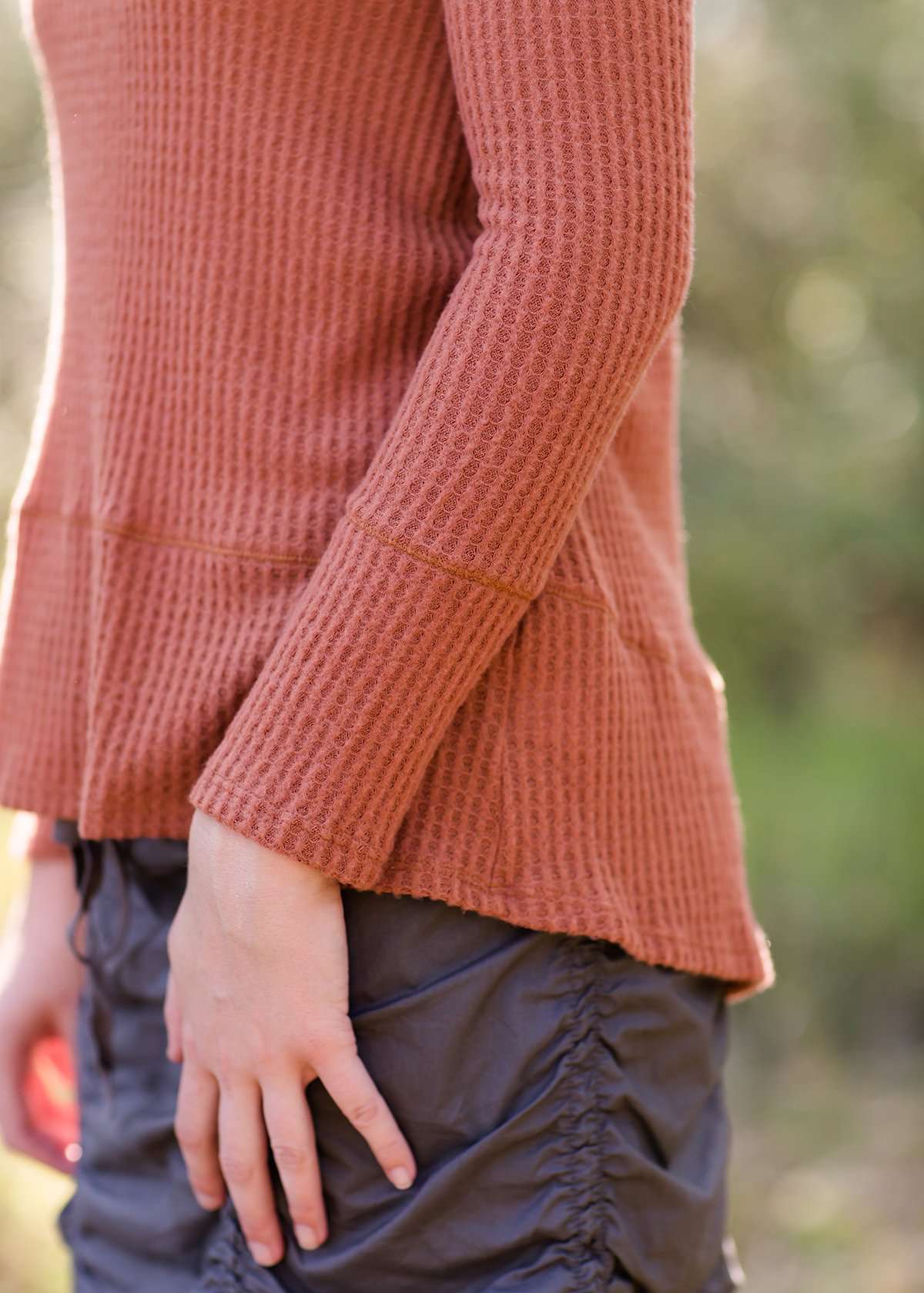 Brick in color, lightweight waffle knit long sleeve top.