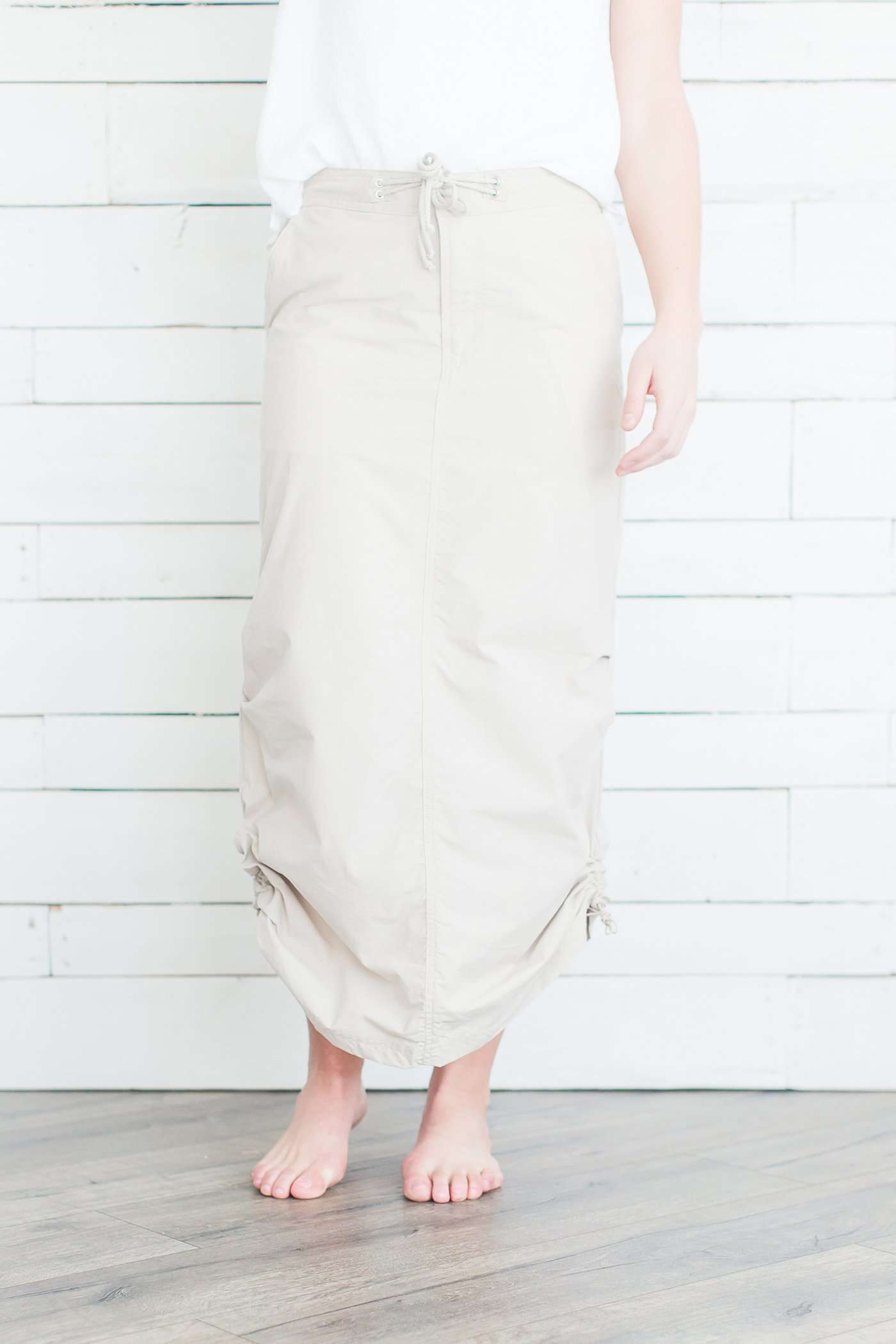 Black, tan or olive option in this long skirt with drawstring waist and side strings to adjust height from midi to maxi