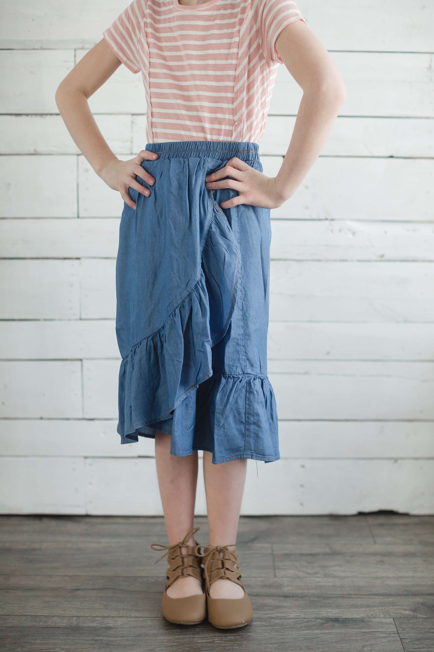 Girls modest denim ruffle below the knee skirt with elastic waistband.