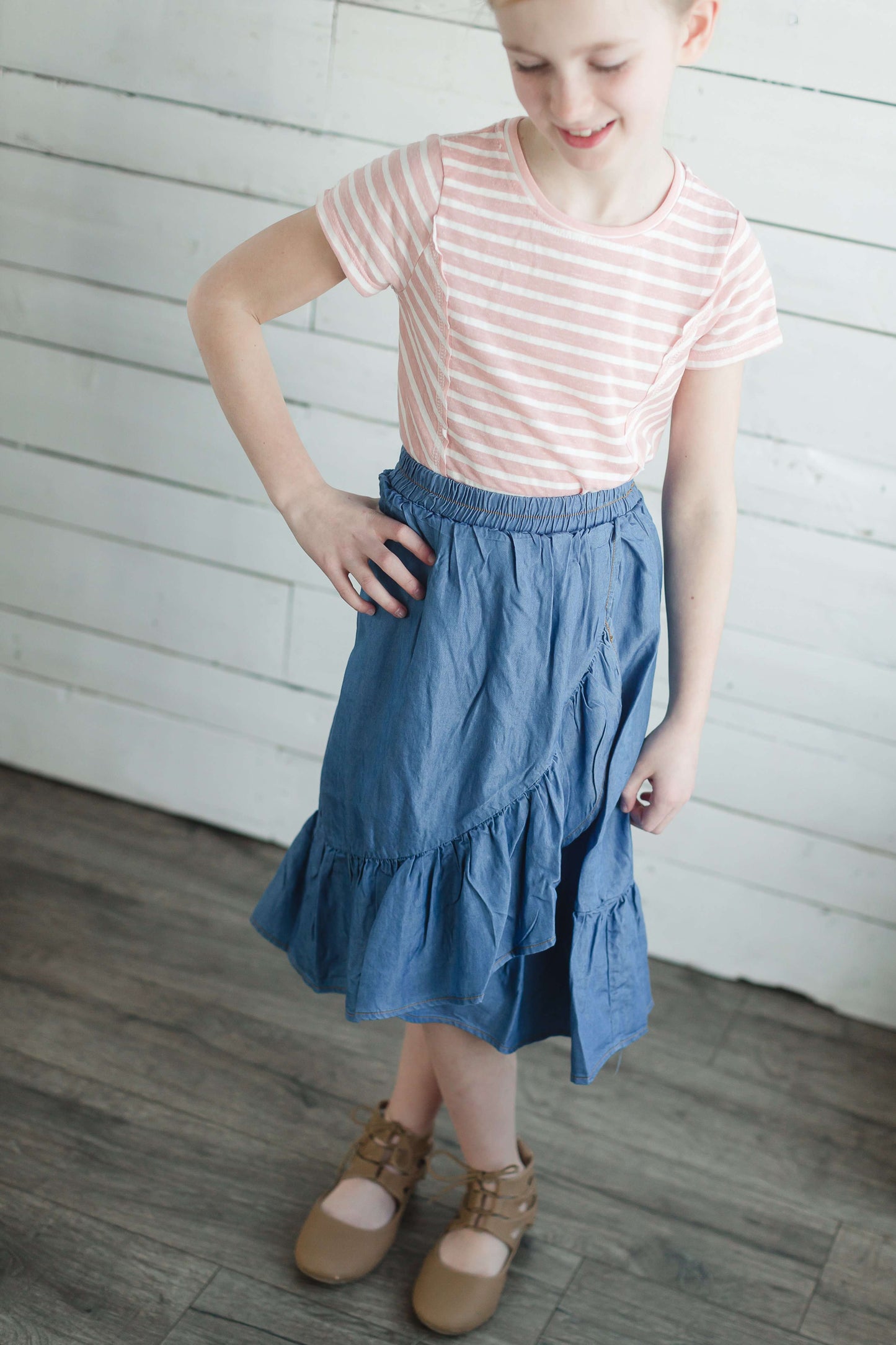 Girls modest denim ruffle below the knee skirt with elastic waistband.