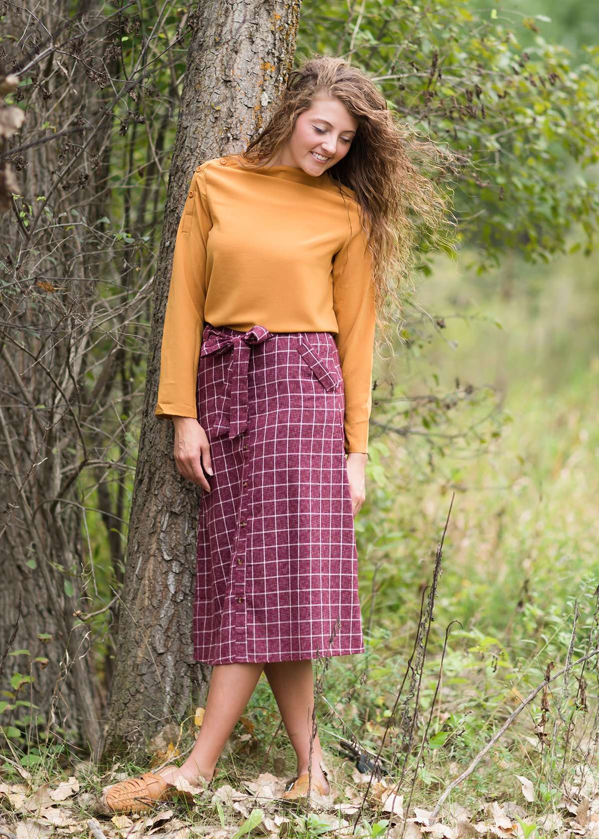 Burgandy with ivory stripe checkers on this below the knee midi skirt and buttons down the front with a back zip, detachable fabric belt and 2 front pockets.