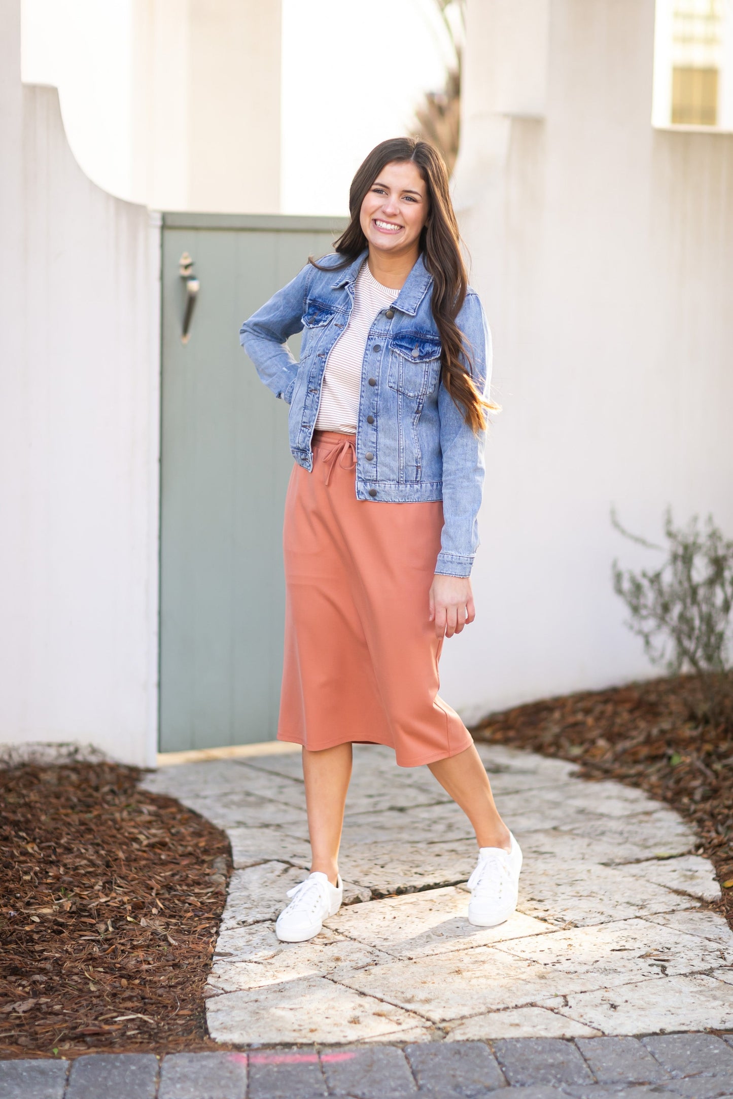A modest salmon pink midi skirt . Featuring a a straight fit, pockets, and a drawstring waist.