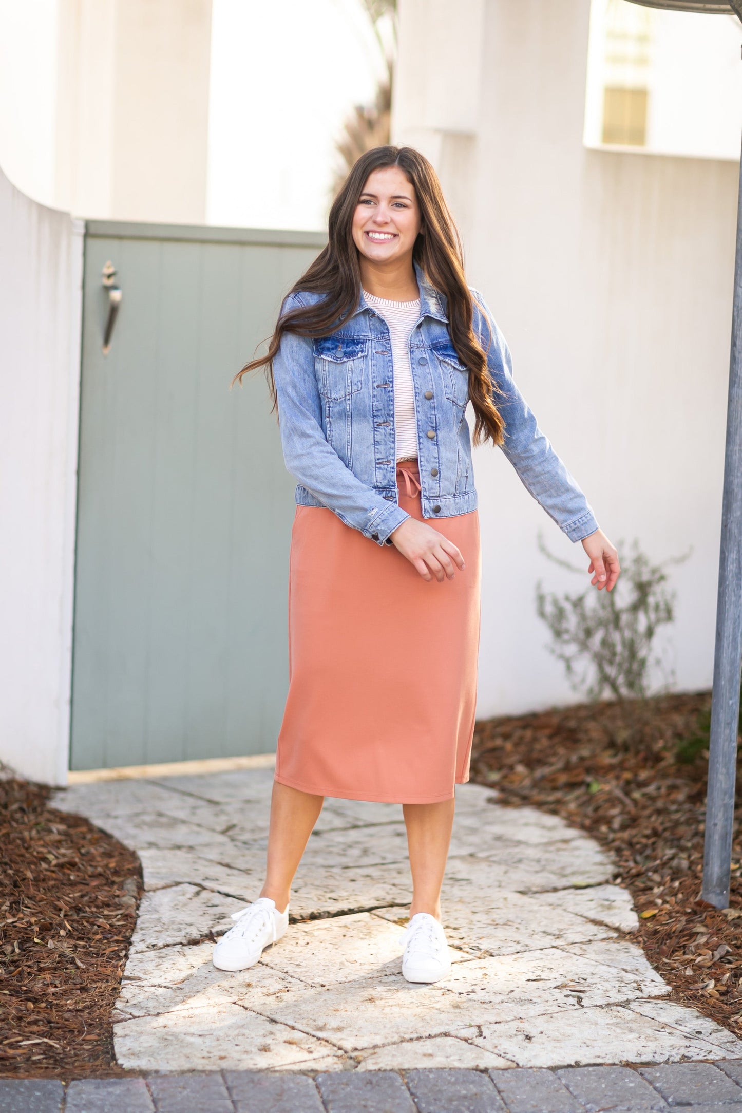 A modest salmon pink midi skirt . Featuring a a straight fit, pockets, and a drawstring waist.
