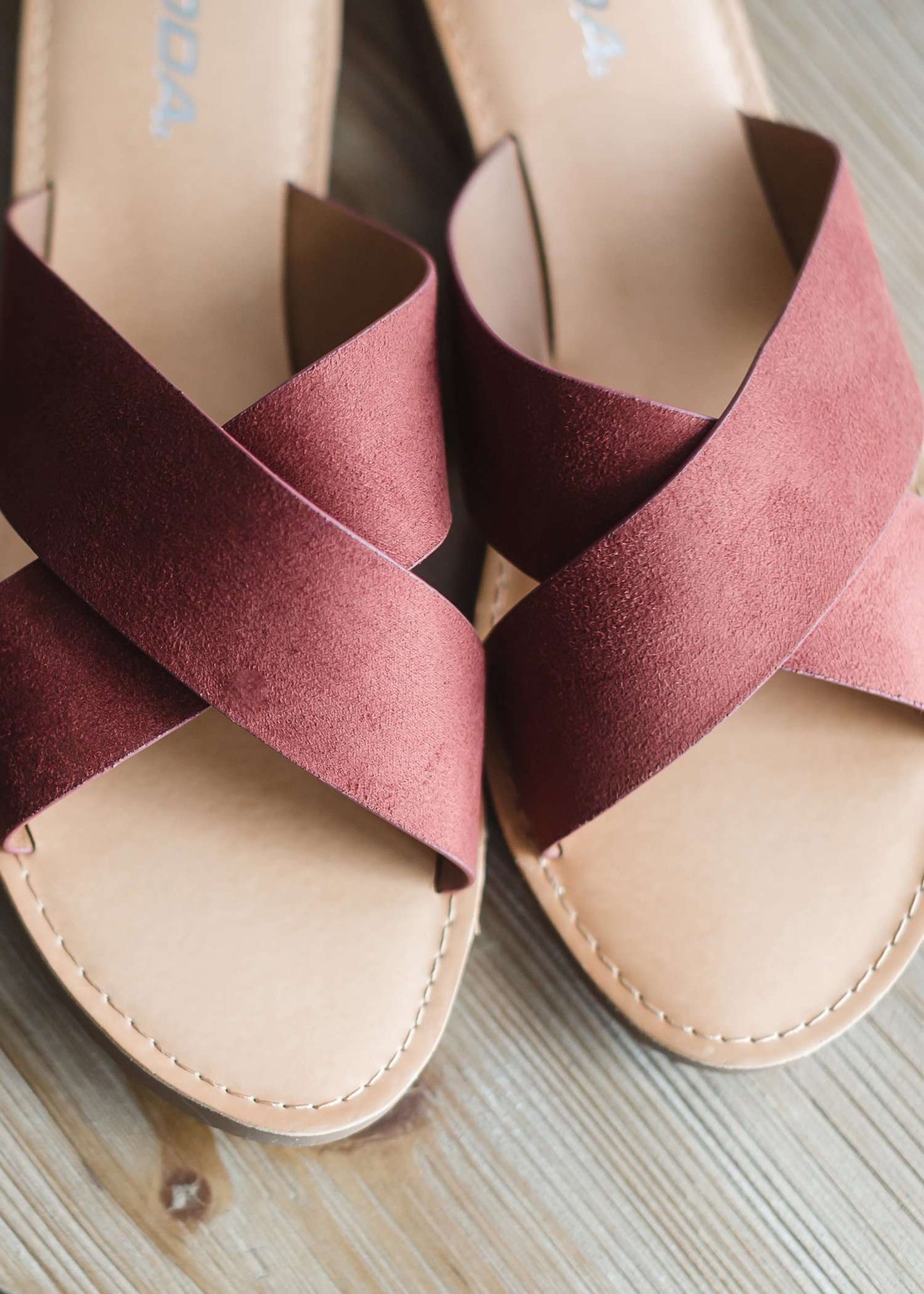 Slide on sandals with a criss cross top