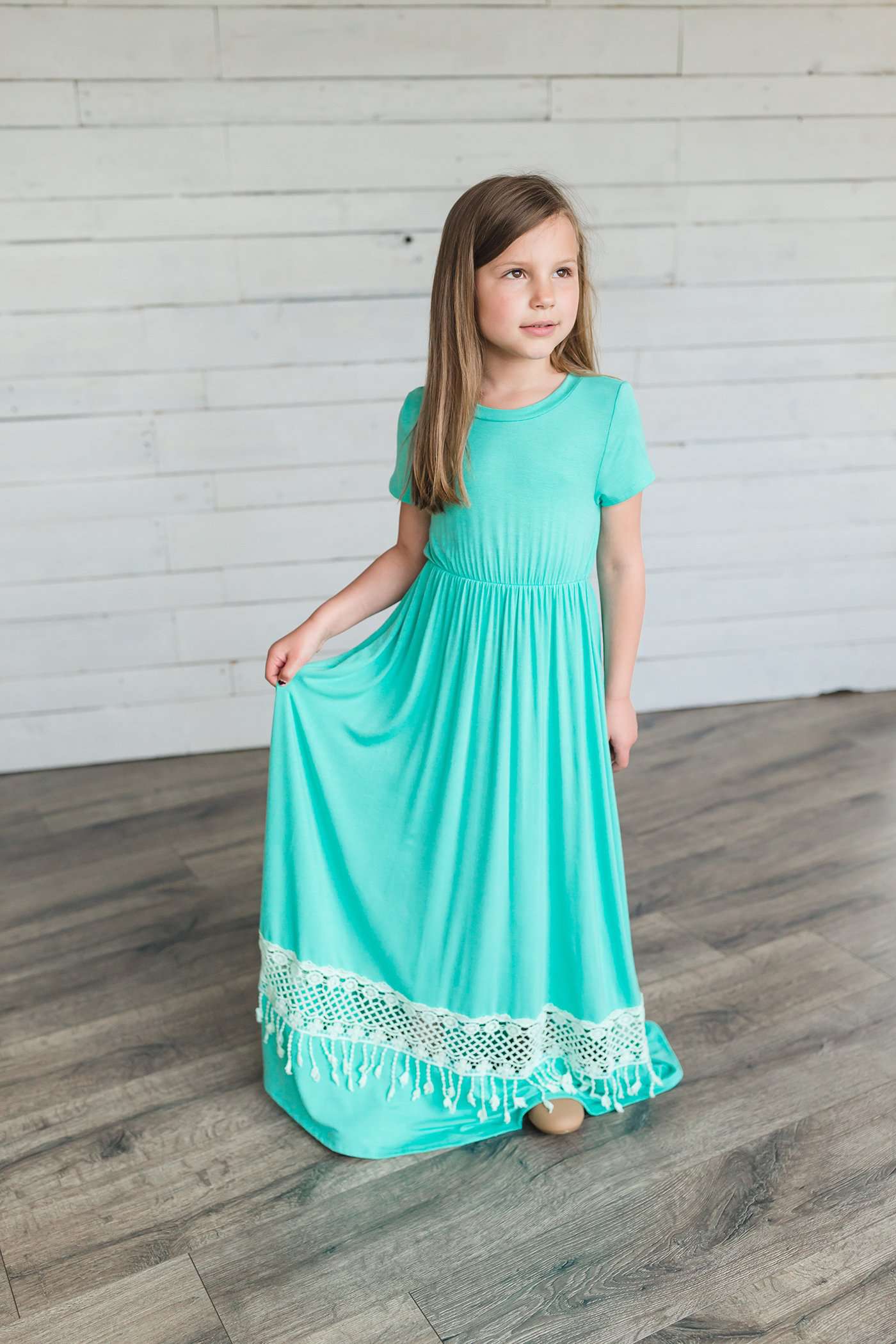 coral or mint colored short sleeve girls maxi dress with crochet detail at the bottom and elastic waist.