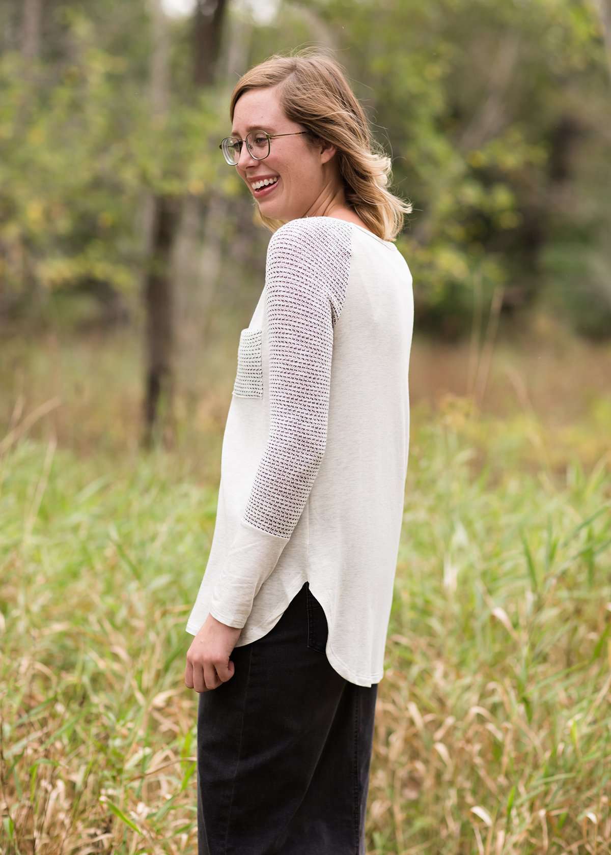 White top with grey contrast long sleeves and front pocket.
