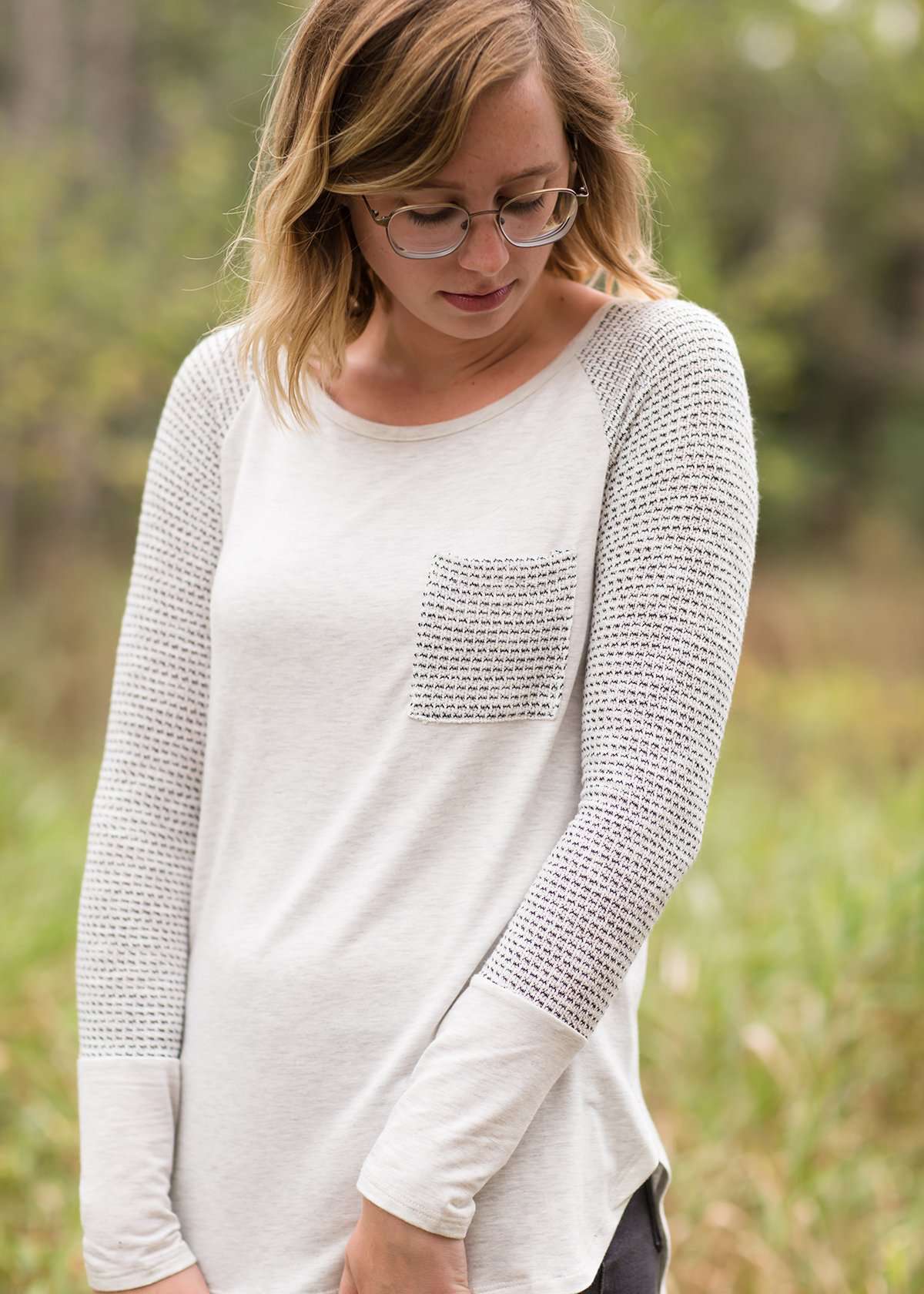 White top with grey contrast long sleeves and front pocket.