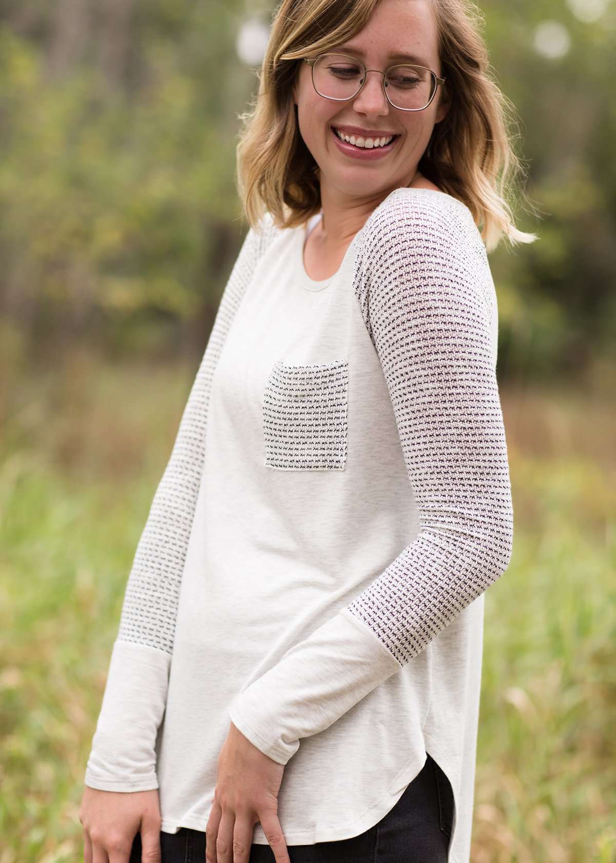 White top with grey contrast long sleeves and front pocket.