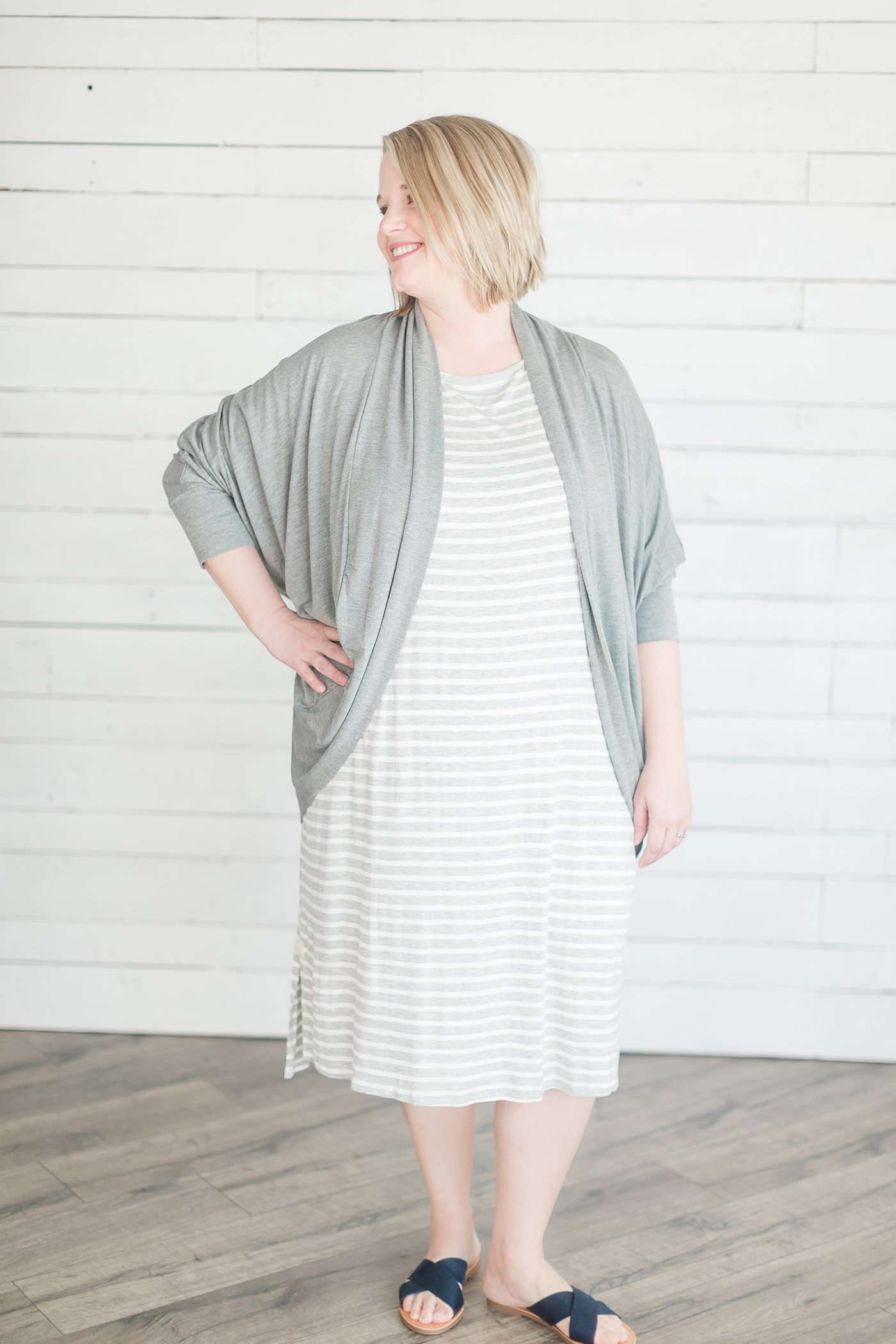 grey and white striped three quarter length sleeve midi dress with a modest crew neck top and side slit.