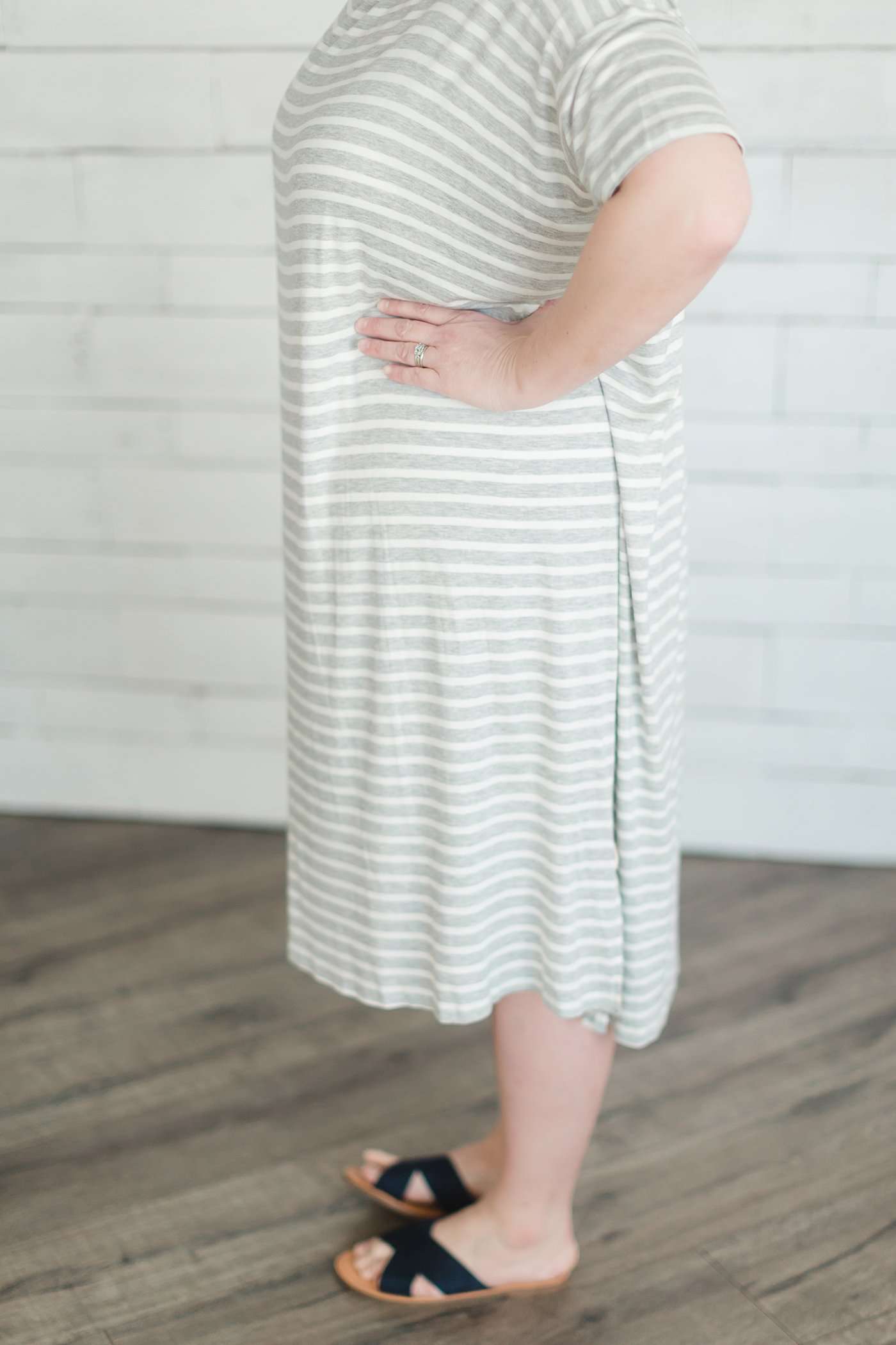grey and white striped three quarter length sleeve midi dress with a modest crew neck top and side slit.