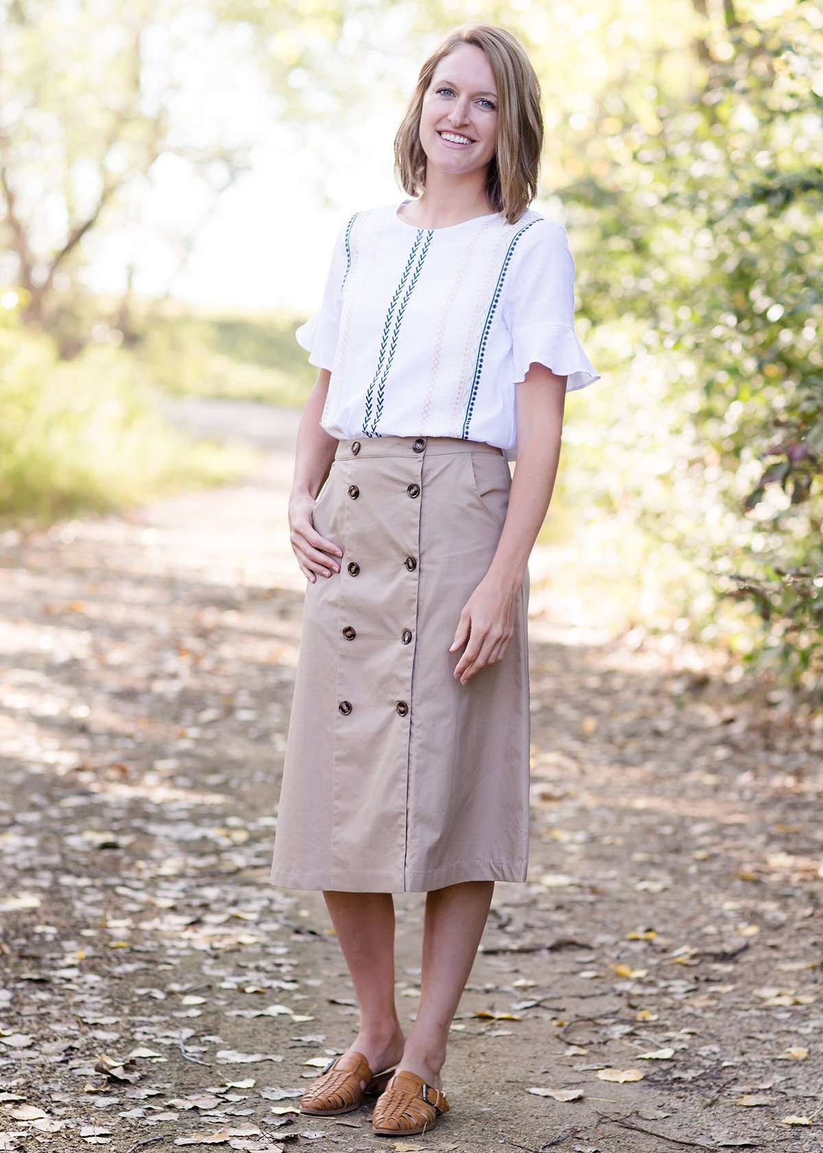 Taupe midi length skirt with double buttons down the front.