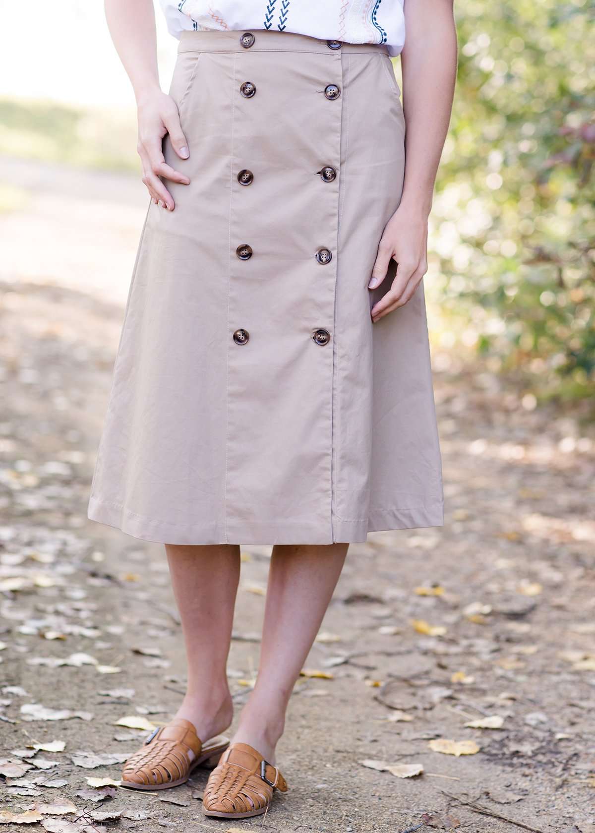 Taupe midi length skirt with double buttons down the front.