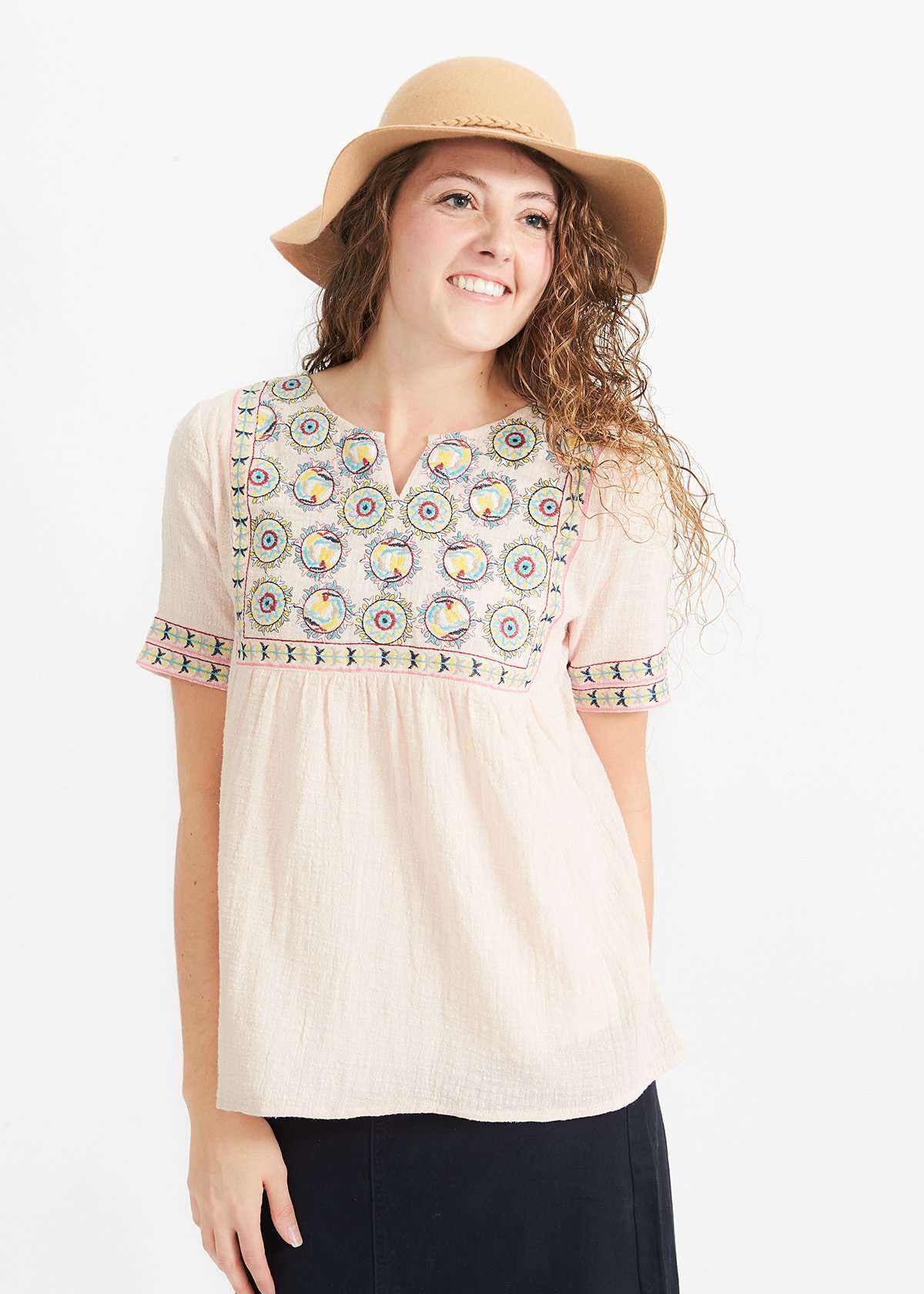 Woman wearing a blush embroidered bohemian style top