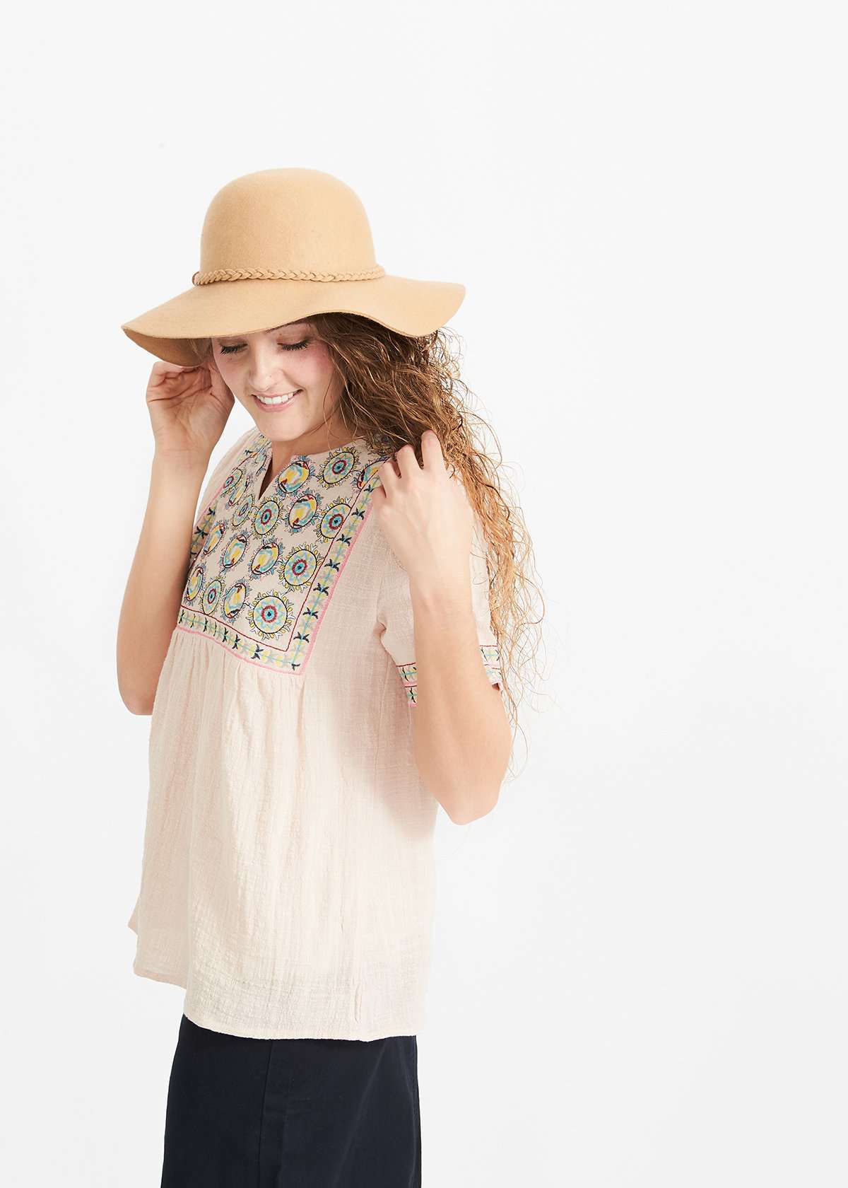 Woman wearing a blush embroidered bohemian style top
