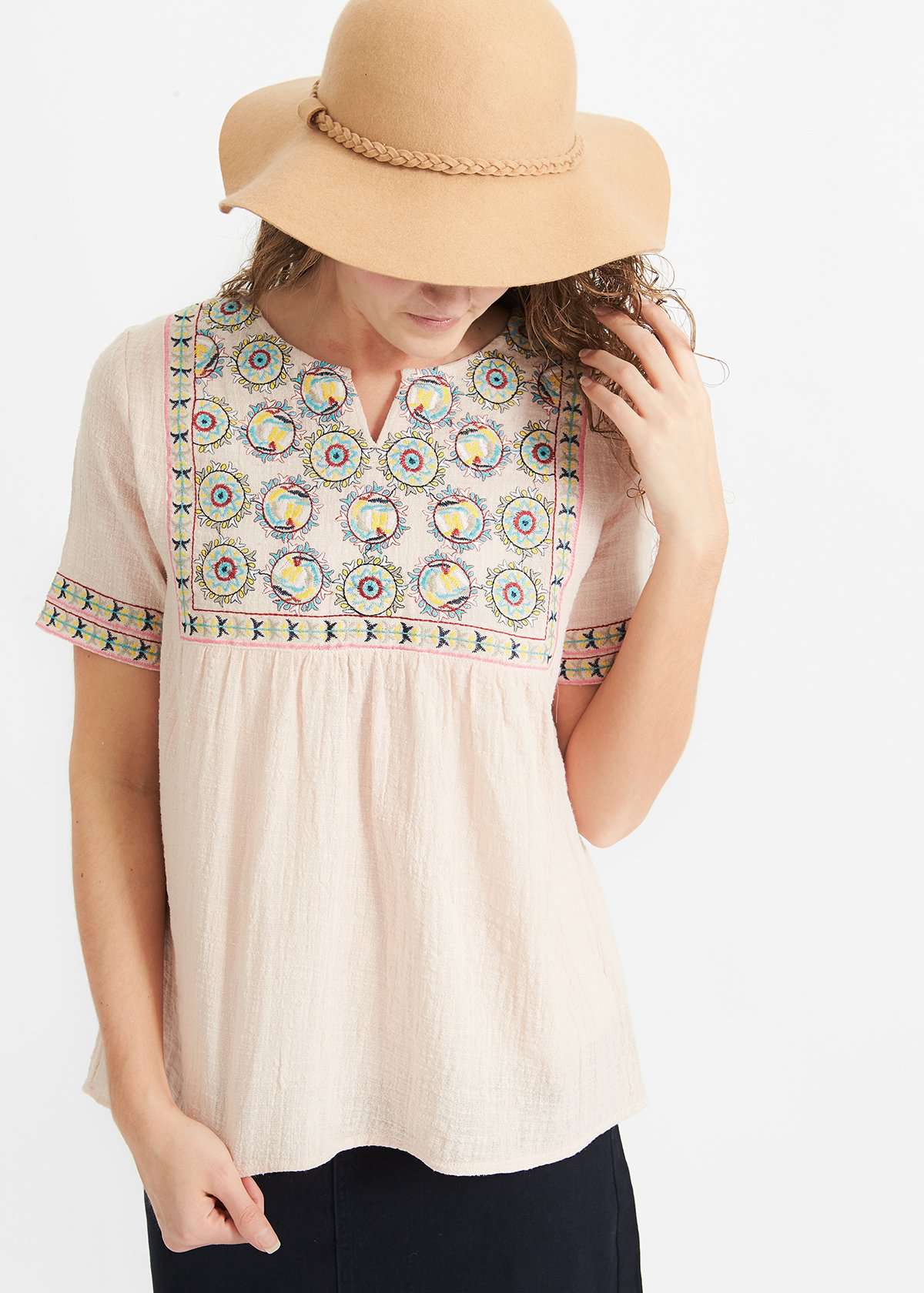 Woman wearing a blush embroidered bohemian style top