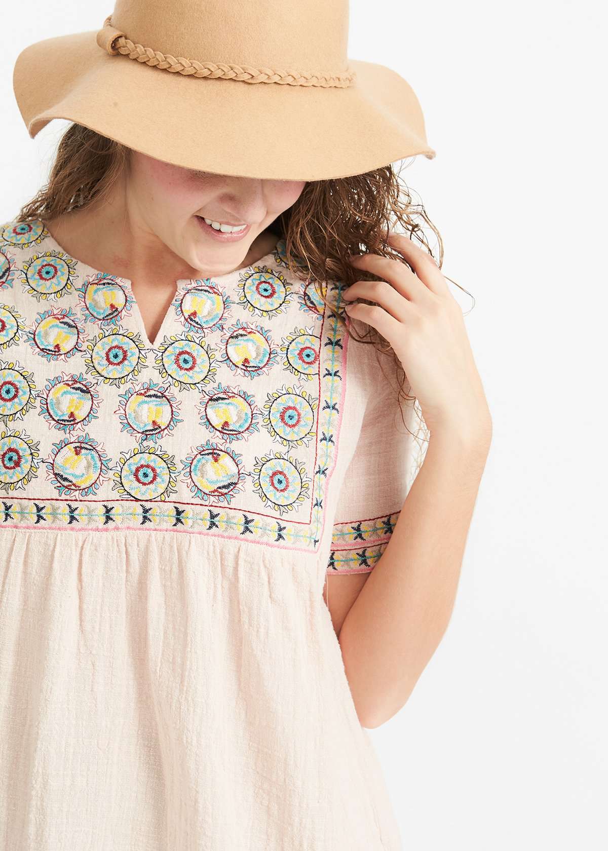 Woman wearing a blush embroidered bohemian style top