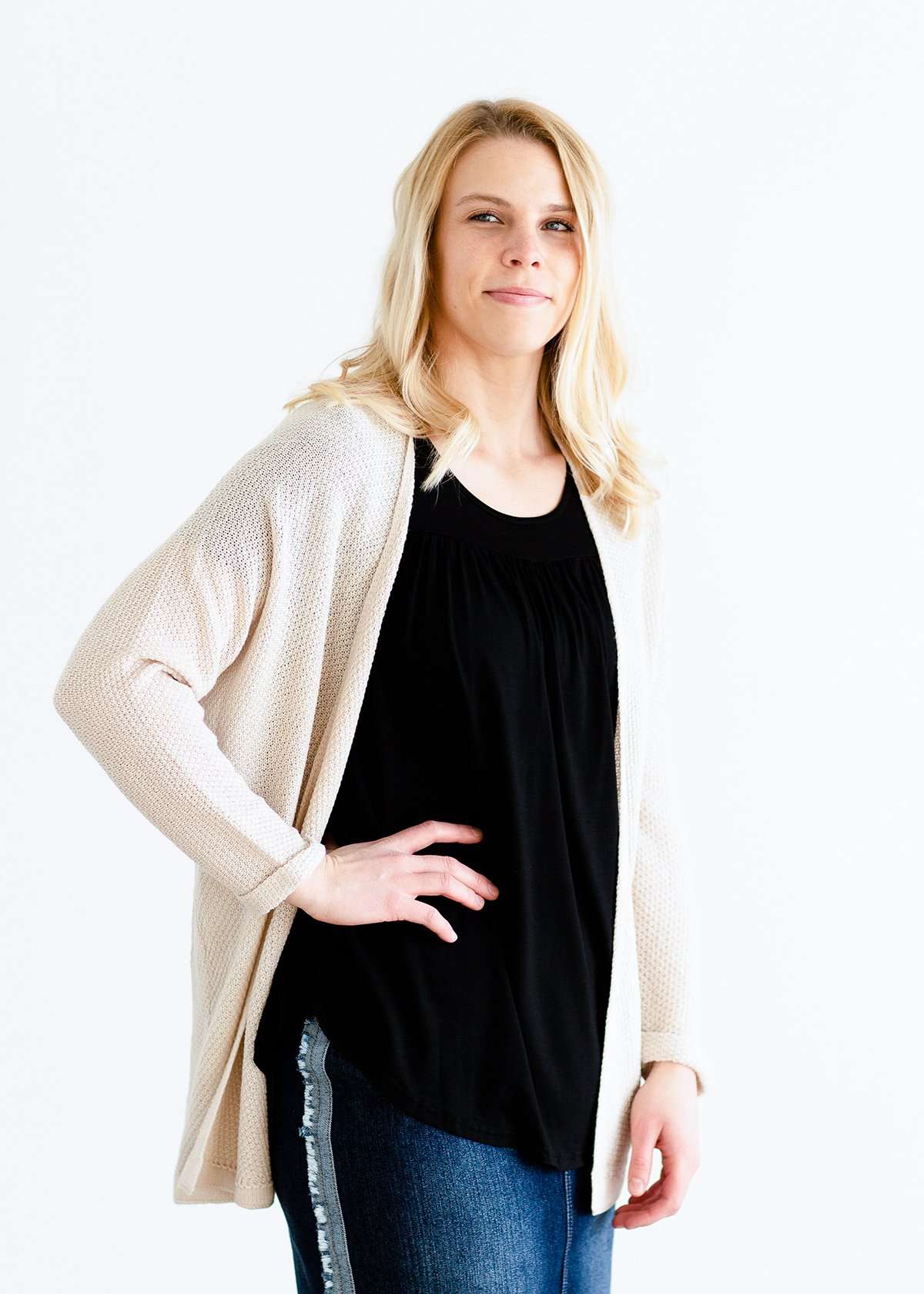 Woman wearing a modest black top with a denim jean skirt
