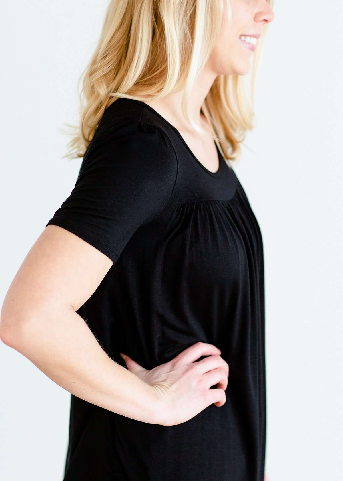 Woman wearing a modest black top with a denim jean skirt