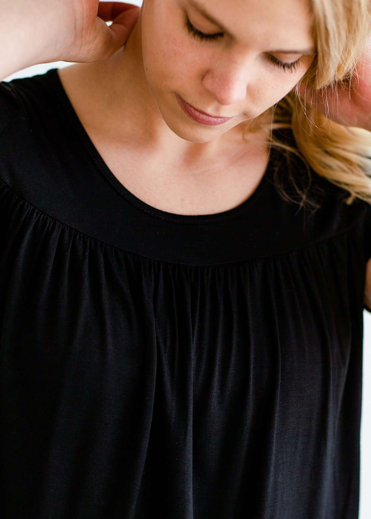 Woman wearing a modest black top with a denim jean skirt