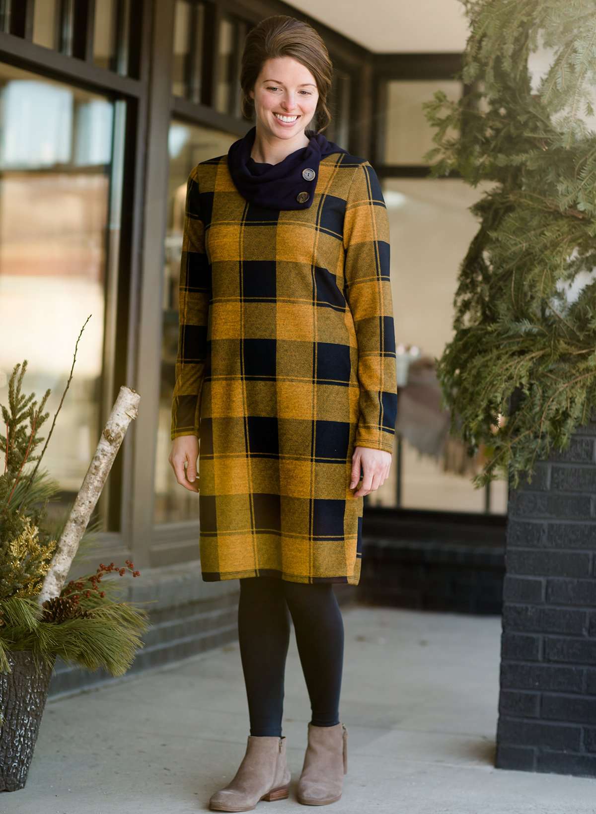 Woman wearing a Mustard and Navy buffalo check, flannel shift dress at Inherit Clothing Company.
