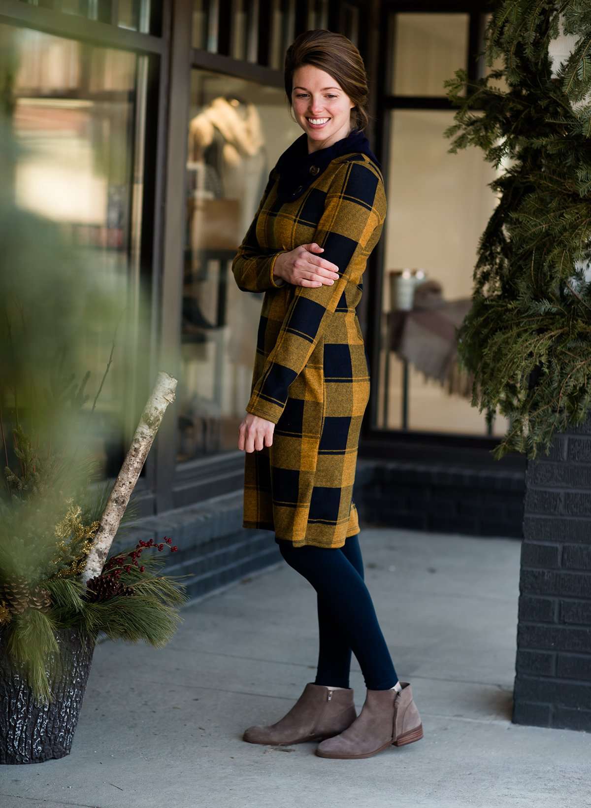 Woman wearing a Mustard and Navy buffalo check, flannel shift dress at Inherit Clothing Company.