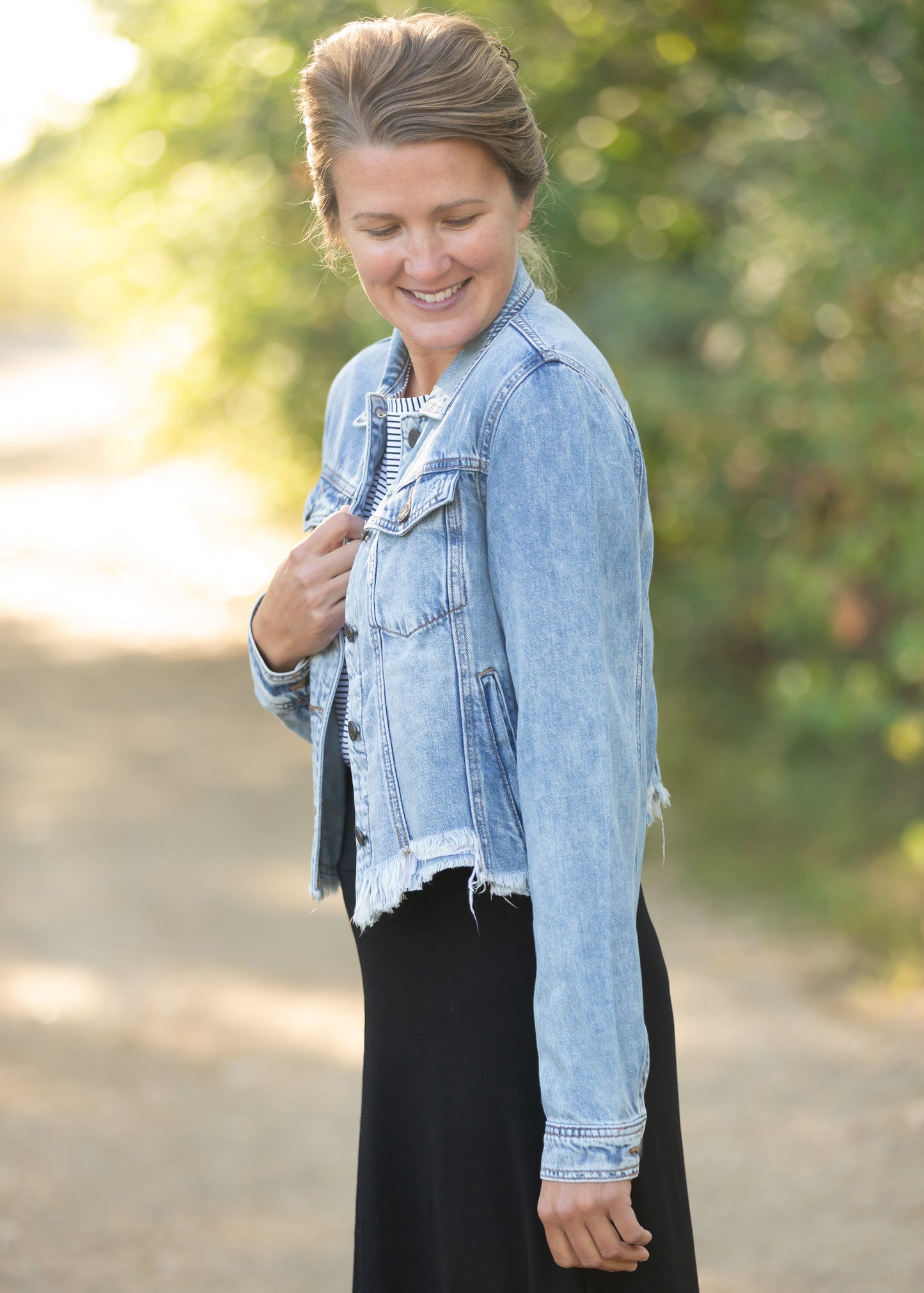 Frayed Light Wash Denim Jean Jacket with brass front buttons, a classic collar and a frayed hem.
