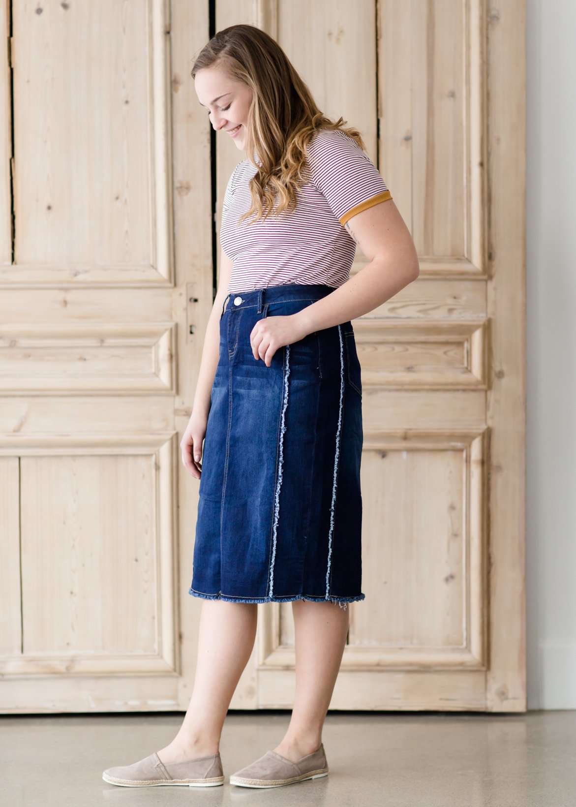 modest woman wearing a fringe dark denim below the knee skirt