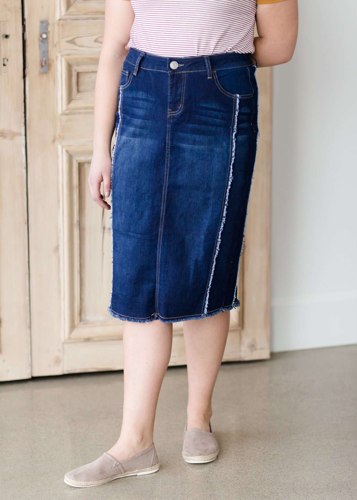 modest woman wearing a fringe dark denim below the knee skirt