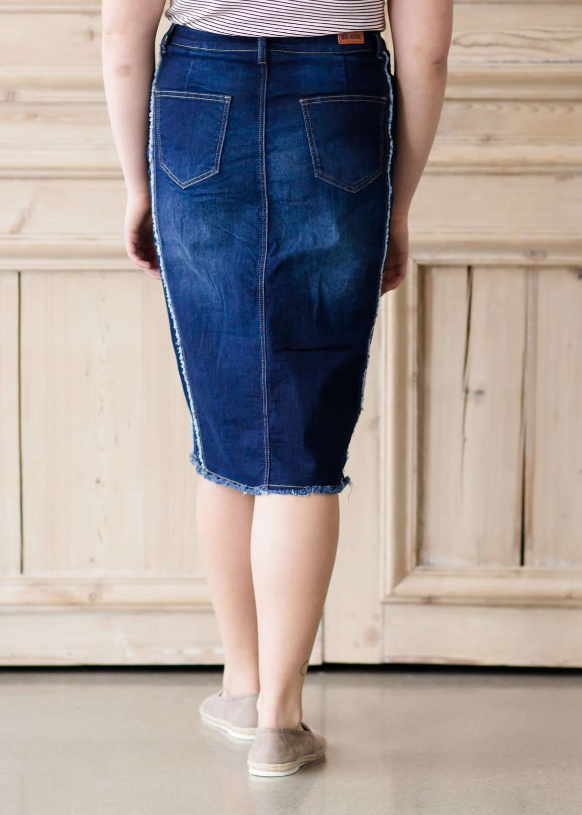 modest woman wearing a fringe dark denim below the knee skirt