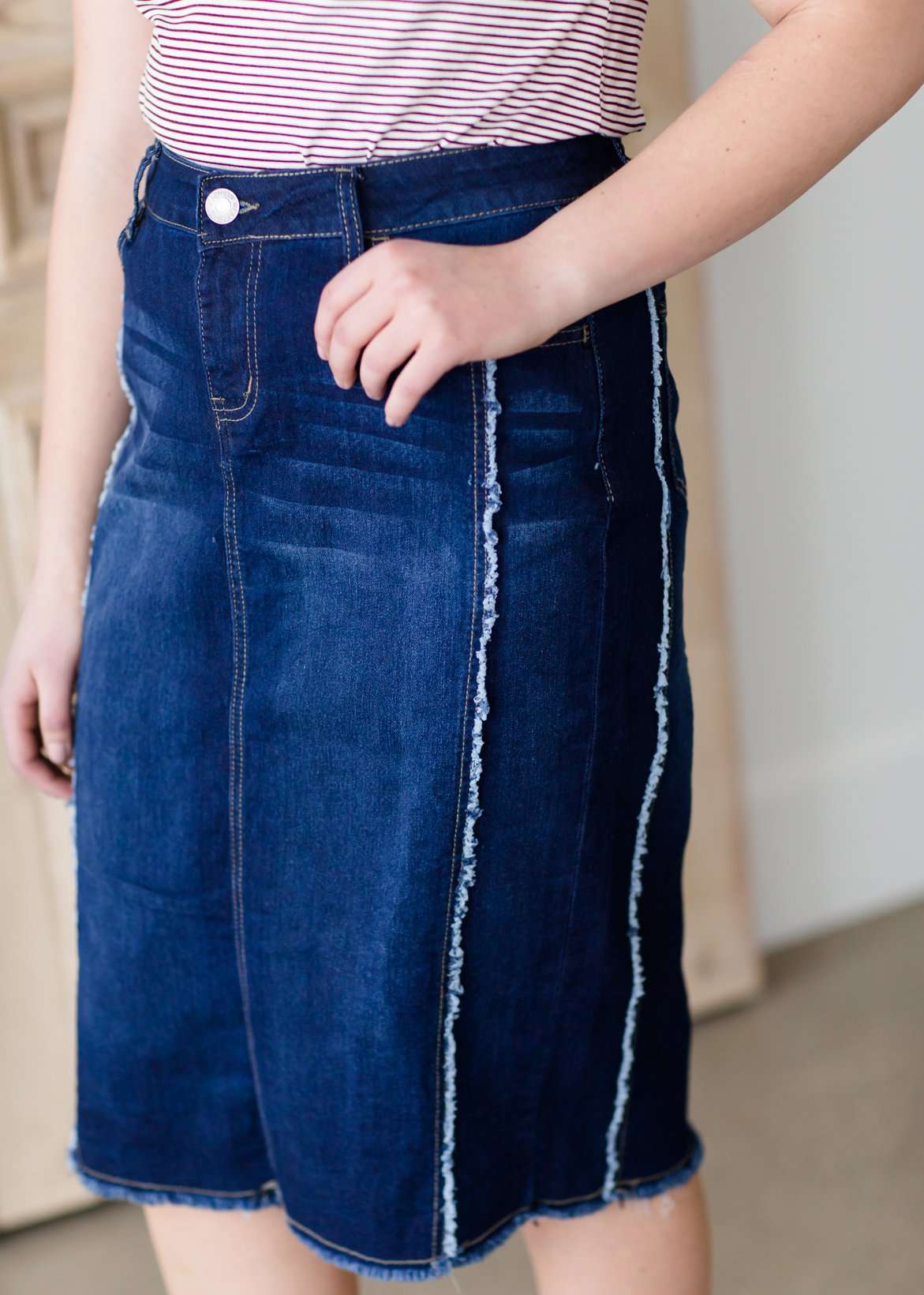 modest woman wearing a fringe dark denim below the knee skirt