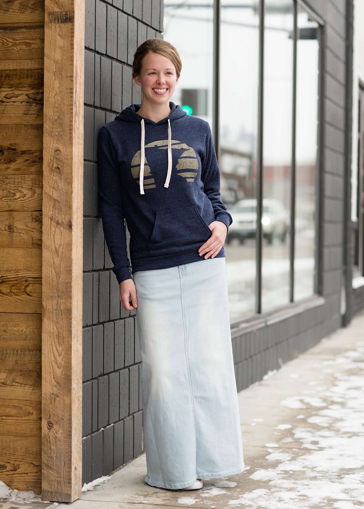 Triblend Minnesota hoodie on a young woman, the hoodie is navy with a gold MN emblem on front and gray with a purple MN emblem on front.