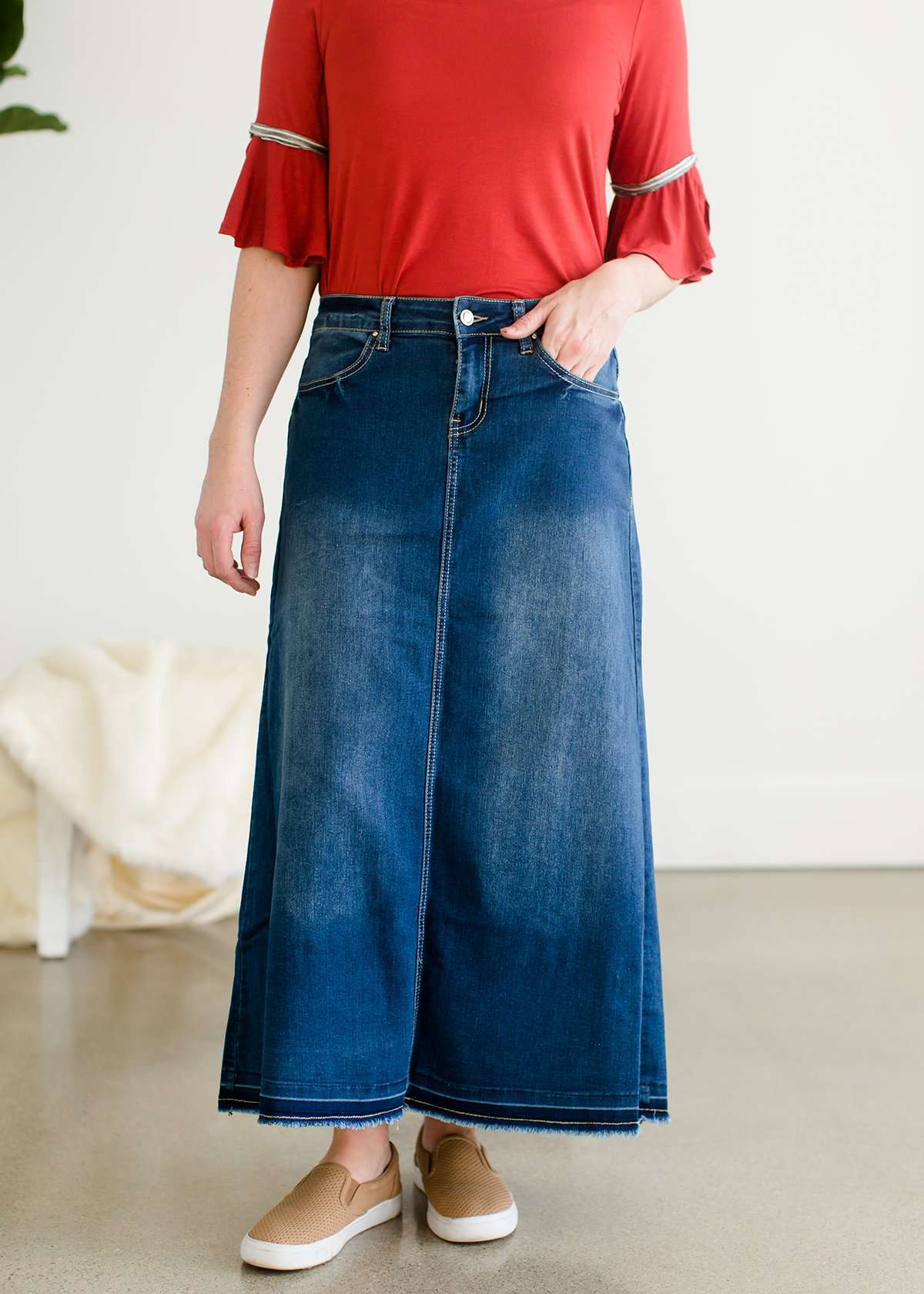 A-line long denim skirt with no slit and a raw edge hem.