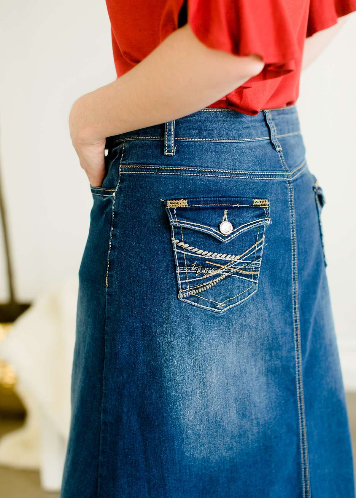 A-line long denim skirt with no slit and a raw edge hem.